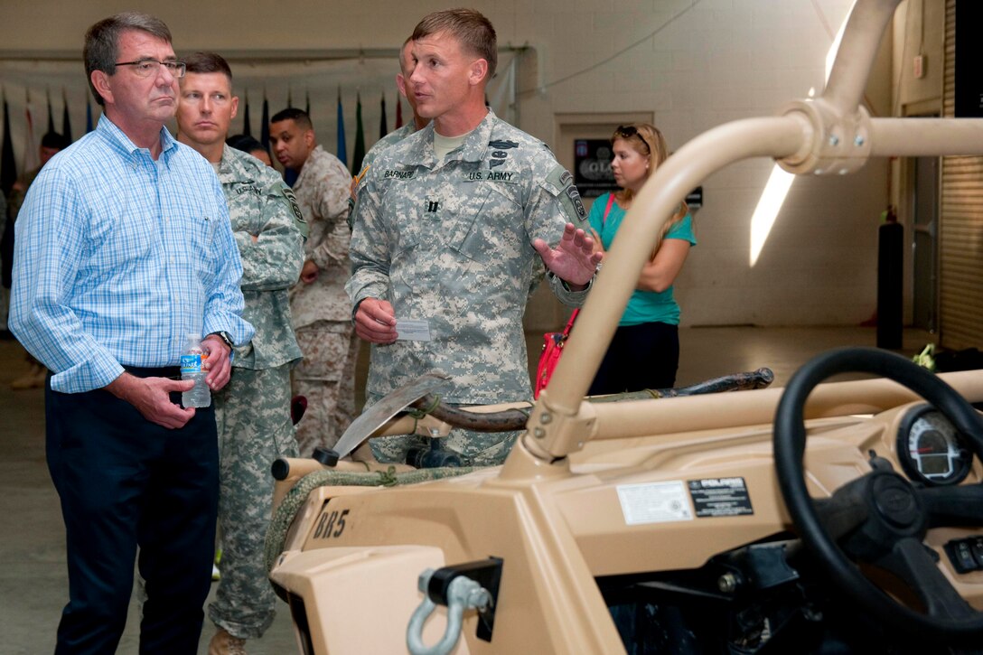 Army Capt. Virgil Barnard, right, briefs Defense Secretary Ash Carter on the capabilities of the Polaris MRZR-4 light tactical all-terrain vehicle on Fort Bragg, N.C., July 10, 2015. Barnard is assigned to the 82nd Airborne Division's 1st Battalion, 325th Airborne Infantry Regiment, 2nd Brigade Combat Team.