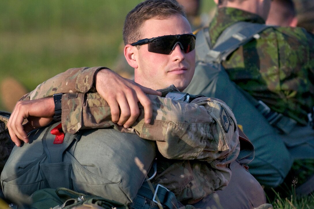 U.S. Army Spc. Sean Toohey awaits a parachute jump after equipment check near Rukla, Lithuania, July 7, 2015. Toohey is a paratrooper assigned to  Company D, 1st Battalion, 503rd Infantry Regiment, 173rd Infantry Brigade Combat Team, Airborne.