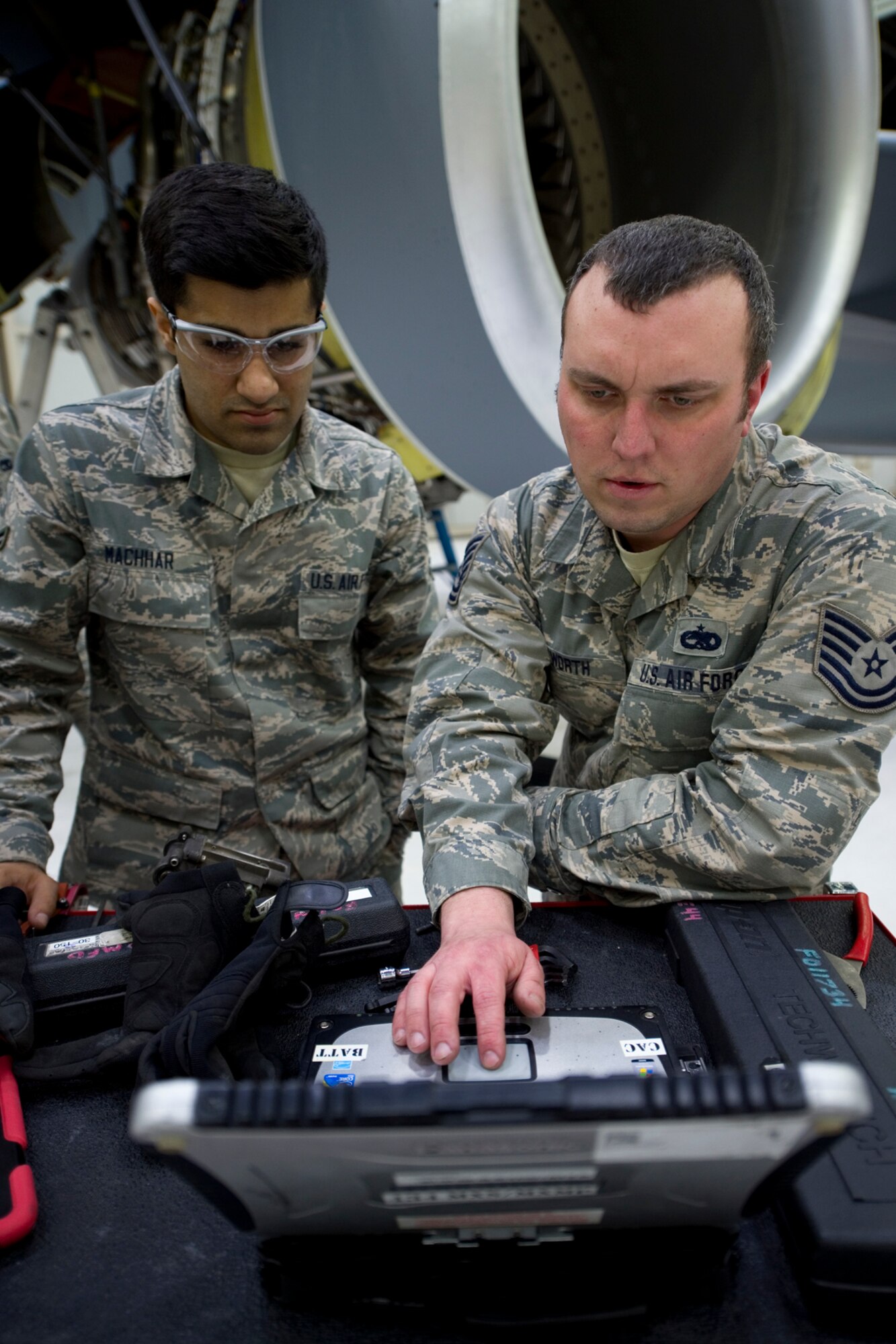 Tech. Sgt. Nathan Foxworth, 434th Maintenance Squadron aerospace propulsion craftsman, right, instructs Senior Airman Priyanh Machar, 434 MXS aerospace propulsion apprentice, on the procedures for using a technical order to remove and replace variable bleed valves on a CFM-56 turbofan engine from a KC-135R Stratotanker at Grissom Air Reserve Base, Ind., March 15, 2015. The shop, comprised of four Air Force Reserve technicians, a full time civilian engine manager and eight traditional reservists, completes a variety of inspections including time compliance technical order inspections, periodic inspections and special hourly inspections. (U.S. Air Force photo/2nd Lt. Mark Orders-Woempner)