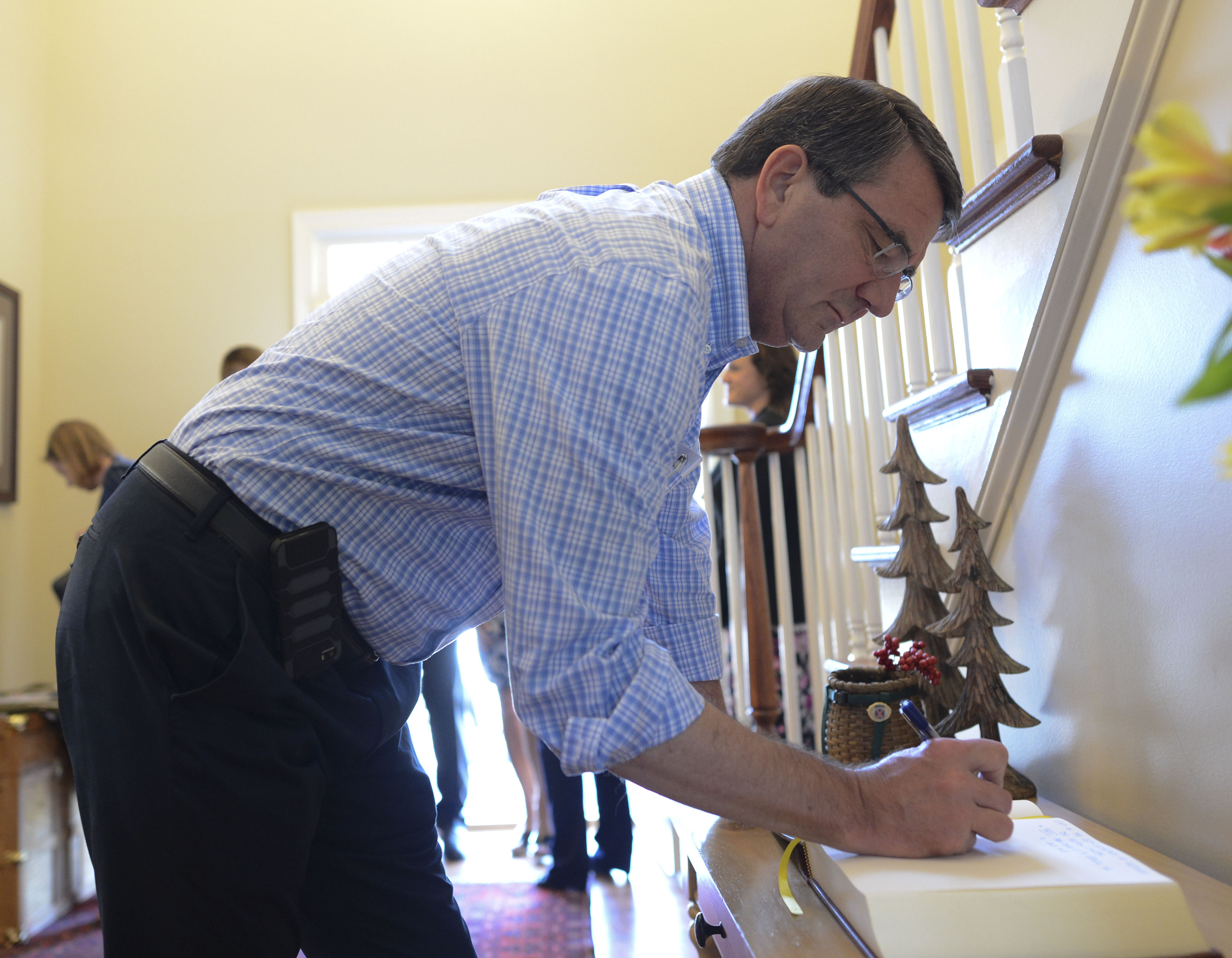 Defense Secretary Ash Carter Signs A Guest Book At The House Of Army Lt Gen Stephen