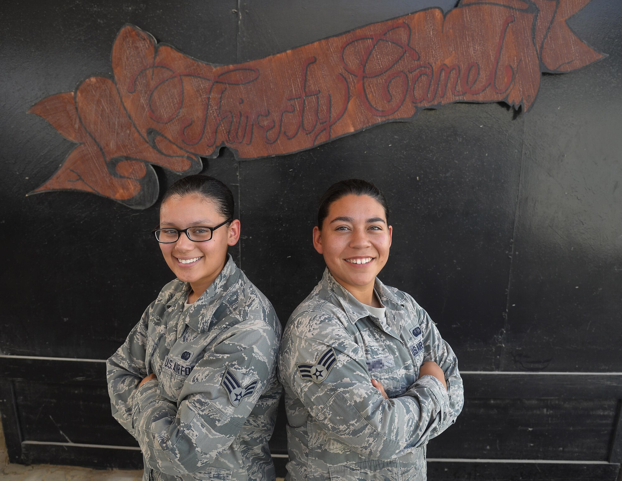 Senior Airmen Leslyl, left, and Cynthia, right, are recreation specialists assigned to the Community Activity Center at an undisclosed location in Southwest Asia. The Community Activity Center is open 24-hours a day and provides Airmen a place to relax and enjoy themselves. (U.S. Air Force photo/Tech. Sgt. Christopher Boitz)