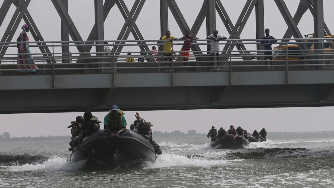 U.S. Marines assigned to Special-Purpose Marine Air-Ground Task Force Crisis Response-Africa and Seneglaese Compagnie Fusilier de Marin Commandos execute a “line of stern” patrolling formation during small-boat operations training in St. Louis, Senegal, July 3, 2015. Approximately 20 Marines, sailors and coast guardsmen with the unit spent the week teaching more than 30 members of the Fusilier Marins small-boat operations and maintenance skills. 