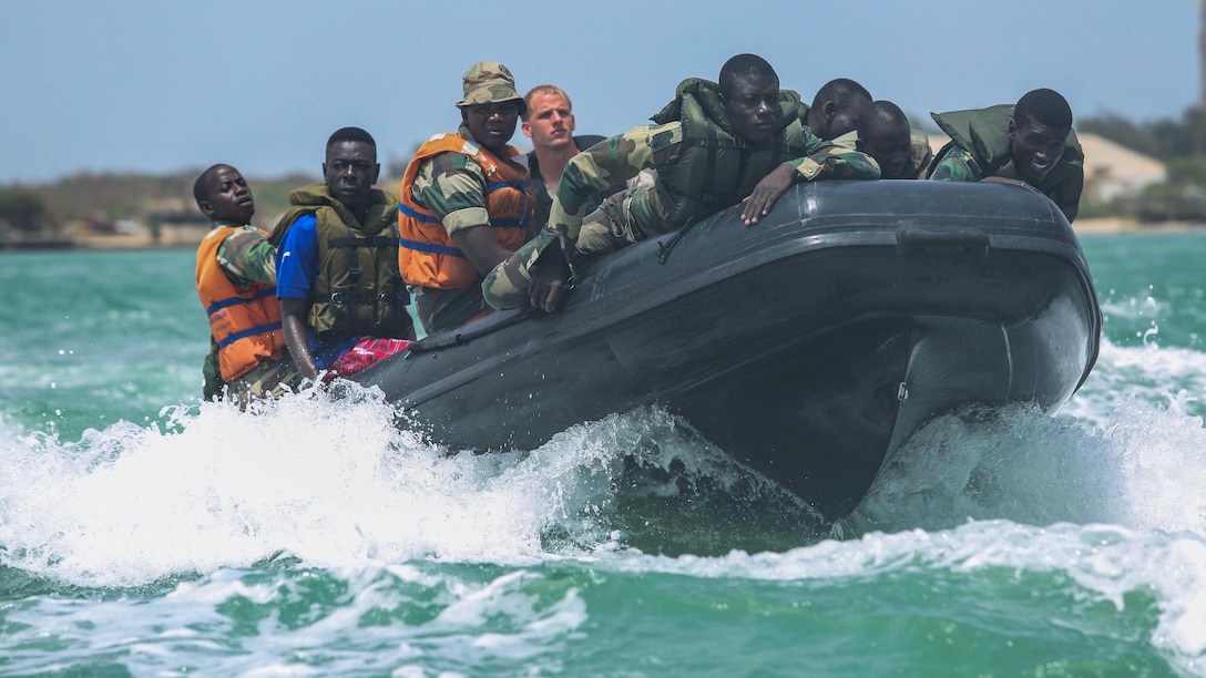 A U.S. Marine coxswain with Special-Purpose Marine Air-Ground Task Force Crisis Response-Africa pilots a zodiac while conducting patrol formations with Senegalese Compagnie Fusilier de Marin Commandos during a small-boat exercise in St. Louis, Senegal, July 1, 2015. Approximately 20 U.S. Marines, sailors and coast guardsmen with the unit spent the week teaching and training members of the Fusilier Marins small-boat skills, including engine maintenance, broaching and riding, chase boats and man overboard drills. 
