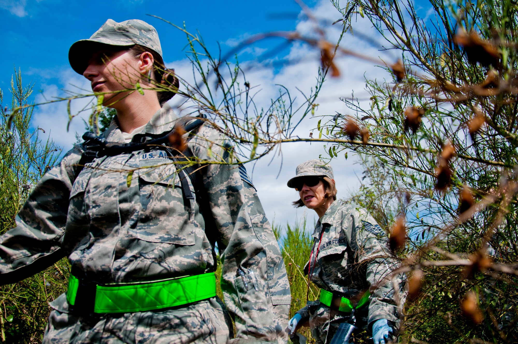 Medics from the 446th Aeromedical Staging Squadron make their way through the woods for the Care Under Fire exercise at Joint Base Lewis-McChord, July 12, 2015.  The Care Under Fire exercise was designed locally by the 446th ASTS in order to simulate combat conditions and establish team oriented training scenarios. Medics were offered land navigation training in order to enhance their combat readiness in austere locations. (U.S. Air Force photo by Senior Airman Daniel Liddicoet/Released)