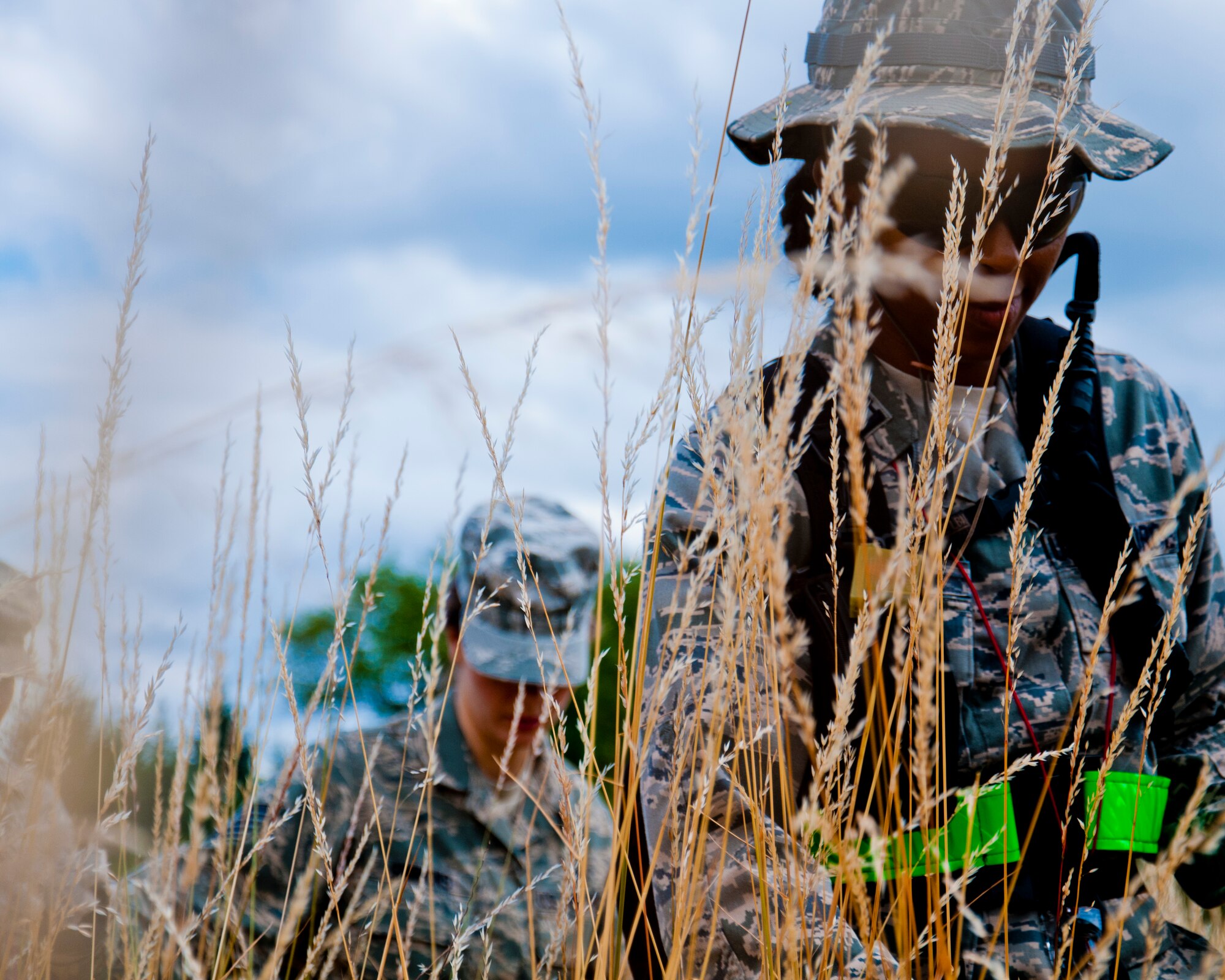 Medics from the 446th Aeromedical Staging Squadron make their way through the woods for the Care Under Fire exercise at Joint Base Lewis-McChord, July 12, 2015.  The Care Under Fire exercise was designed locally by the 446th ASTS in order to simulate combat conditions and establish team oriented training scenarios. Medics were offered land navigation training in order to enhance their combat readiness in austere locations. (U.S. Air Force photo by Senior Airman Daniel Liddicoet/Released)