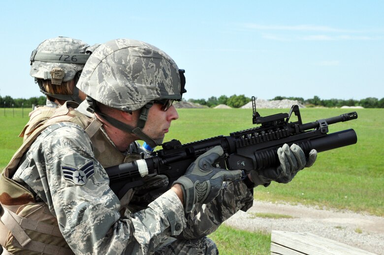 Senior Airman Jared Claxton prepares to fire a practice round from an M203 grenade launcher during weapons familiarization training at McConnell Air Force Base, Kan., July 12, 2014. The M203 is a single-shot 40mm under-barrel grenade launcher that is attached the underside of a M4 carbine rifle. The training is an annual requirement to keep the Airmen current on the weapons skills that will be required of them on post during a deployment. (U.S. Air Force photo by Capt. Zach Anderson)