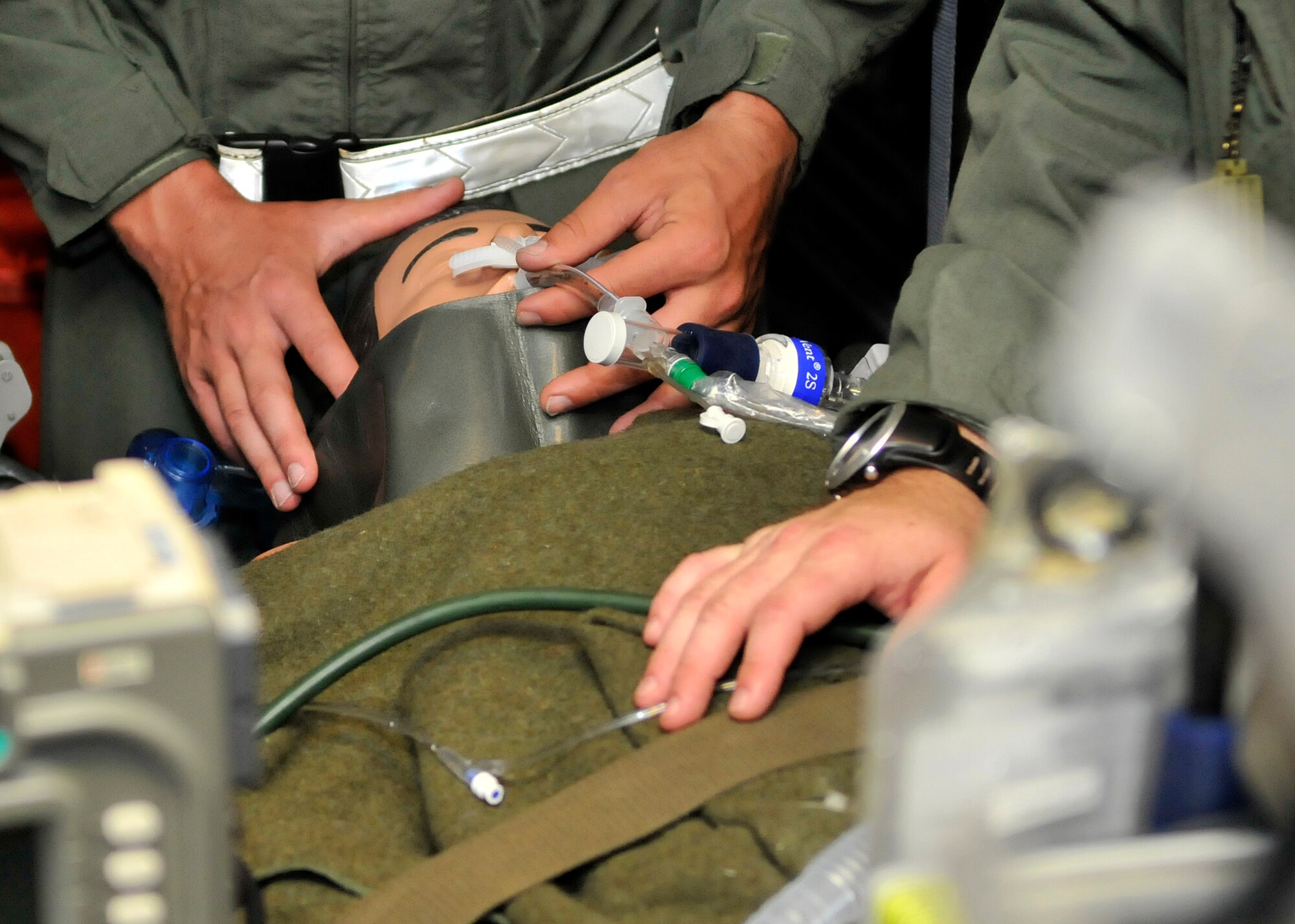 Airmen treat a medical mannequin used to simulate trauma and emergency situations during MEDBEACH 2015 joint service exercise at Patrick Air Force Base, Fla., July 11, 2015. The mannequins are used to simulate real-life injuries that occur during war, preparing Rescue Airmen for what they might encounter overseas.  (U.S. Air Force photo by Tech. Sgt. Michael Means/Released)