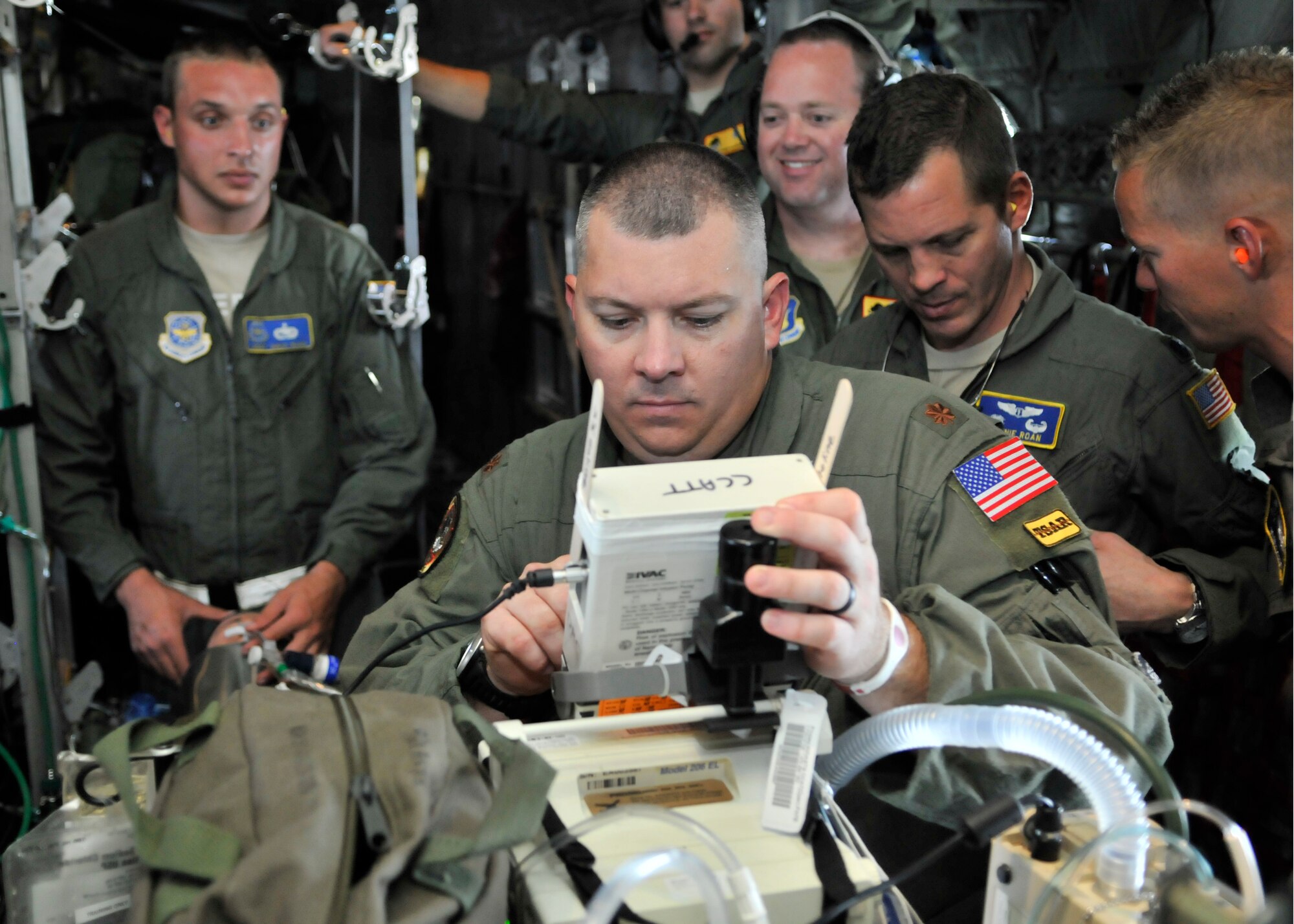 Maj. Derek Brumley, critical care flight nurse, checks life support equipment as Staff Sgt. David Rudd, 920th Rescue Wing Aeromedical Staging Squadron, cardiopulmonary laboratory craftsman, secures a breathing tube during MEDBEACH 2015 joint service exercise at Patrick Air Force Base, Fla., July 11, 2015. Brumley is a Kentucky Air National Guardsman assigned to the 123rd Medical Group and Rudd is a reservist assigned to the 920th ASTS. (U.S. Air Force photo by Tech. Sgt. Michael Means/Released)