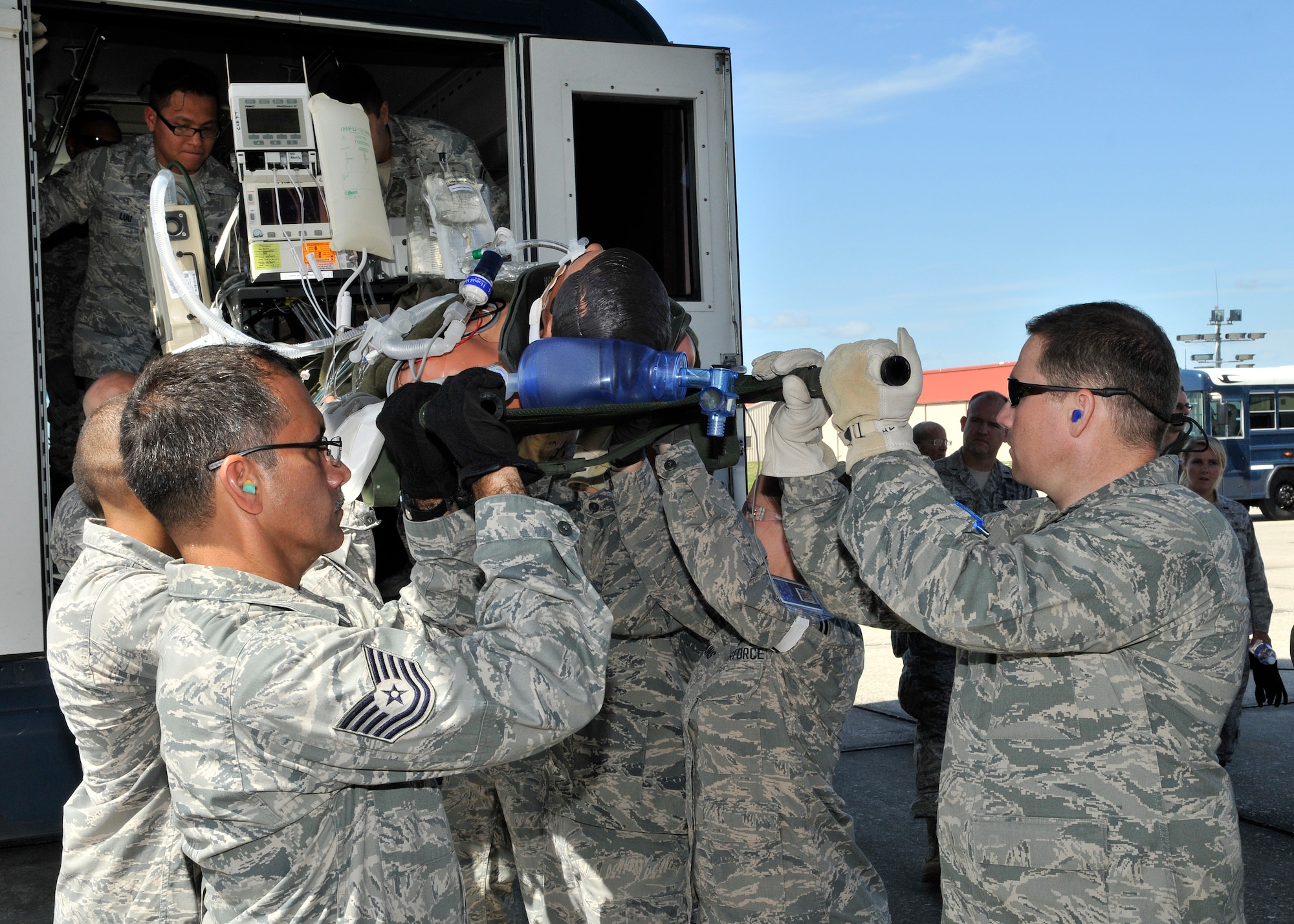 Airmen from the 920th Rescue Wing Aeromedical Staging Squadron, unload a litter during MEDBEACH 2015 joint service exercise at Patrick Air Force Base, Fla., July 11, 2015. This exercise prepares military medical personnel for deployments by providing realistic scenarios that they may see during a wartime situation. (U.S. Air Force photo by Tech. Sgt. Michael Means/Released)