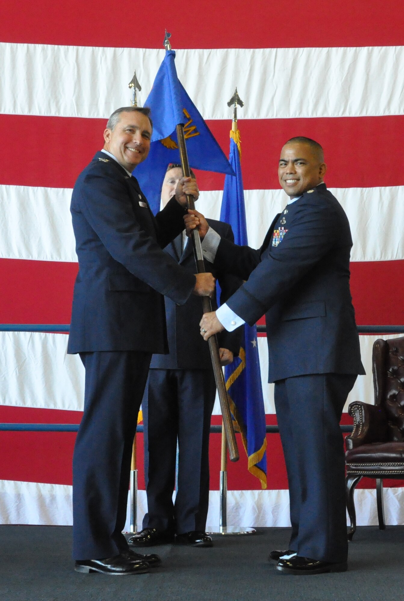 Colonel John M. Breazeale, 301st Fighter Wing commander, transfers the 301st Maintenance Group guidon to Lt. Col. Michael H. Egbalic during an assumption of command ceremony Sunday, July 12 at Naval Air Station Fort Worth Joint Reserve Base, Texas. Egbalic was the commander of the 926th Aircraft Maintenance Squadron, Nellis Air Force Base, Nev. He replaces Colonel James C. Van Housen as commander of the 301 MXG. (U.S. Air Force photo/Staff Sgt. Melissa Harvey)