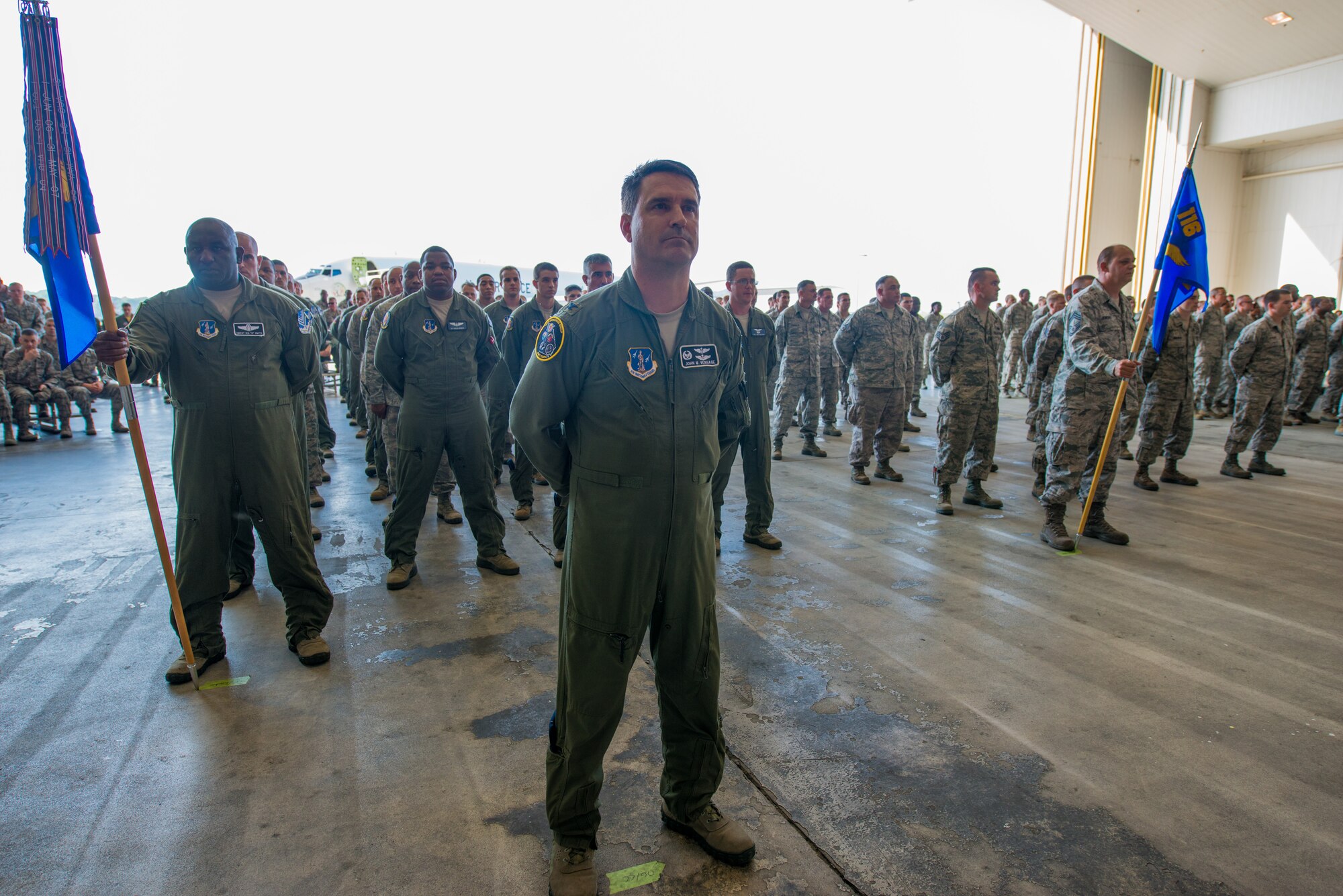 U.S. Airmen from the 116th Air Control Wing (ACW), Georgia Air National Guard, stand at parade rest in a mass formation during the 116th ACW Change of Command ceremony at Robins Air Force Base, Ga., July 11, 2015. Col. Mark Weber assumed command of the 116th ACW from Col. Kevin Clotfelter during the ceremony officiated by Brig. Gen. Jesse Simmons Jr., commander, Georgia Air National Guard. The 116th ACW provides manned, joint airborne command and control, battle management, intelligence, surveillance, and reconnaissance support to combatant commanders around the globe flying the E-8C Joint STARS aircraft. (U.S. Air National Guard photo by Senior Master Sgt. Roger Parsons/Released)