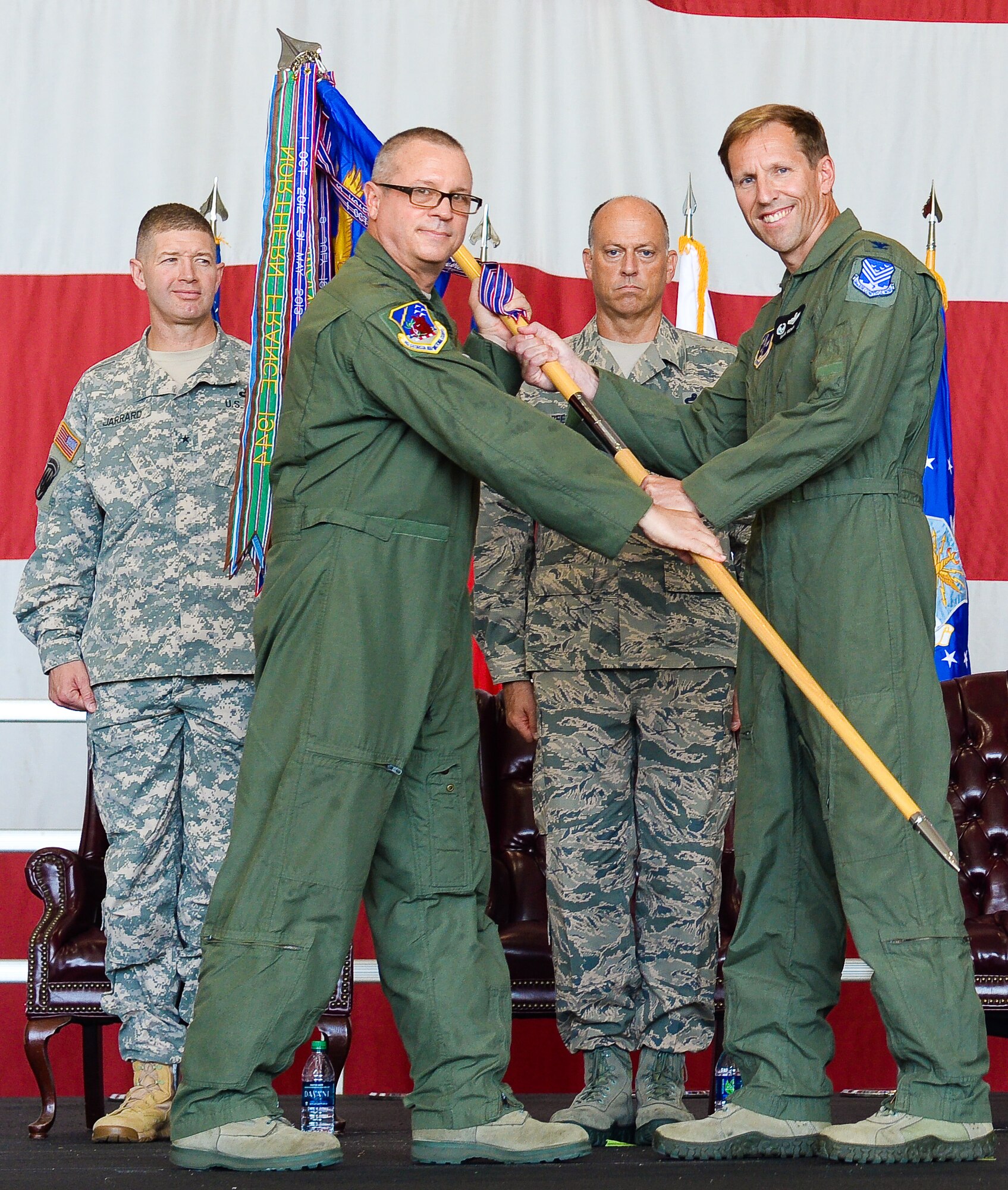 U. S. Air Force Col. Mark Weber, commander, 116th Air Control Wing (ACW), Georgia Air National Guard, accepts the wing guidon from Brig. Gen. Jesse Simmons Jr., commander of the Georgia Air National Guard, as Chief Master Sgt. Joseph Green, 116th ACW command chief, and U.S. Army Brig. Gen. Joe Jarrard, adjutant general, Georgia Department of Defense, look on during a Change of Command ceremony at Robins Air Force Base, Ga., July 11, 2015.  Weber assumed command of the 116th ACW from Col. Kevin Clotfelter during a change of command ceremony officiated by Simmons. The 116th ACW provides manned, joint airborne command and control, battle management, intelligence, surveillance, and reconnaissance support to combatant commanders around the globe flying the E-8C Joint STARS aircraft. (U.S. Air National Guard photo by Tech. Sgt. Regina Young/Released)