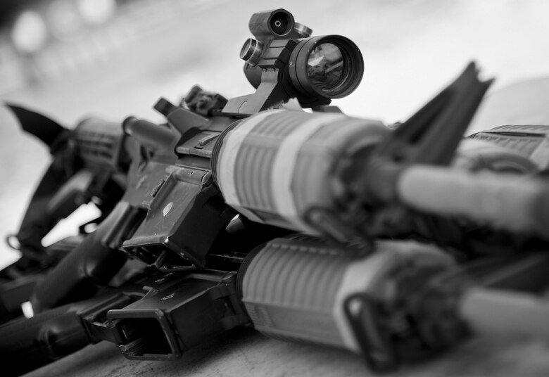 M-4 rifles sit ready for use by 96th Security Forces Squadron Airmen prior to a shoot, move and communicate drill at Eglin Air Force Base, Fla.  The mandatory training requirement is in addition to annual weapons qualification training.  The exercise consists of Airmen firing simmunition ammo while advancing toward, away from and to the side of a target.  This is followed by a building sweep and clear drill. Eglin’s security forces personnel protect and defend the main base, facilities, gates, Duke Field, 7th SFG compound and land and water ranges.  (U.S. Air Force photo/Tech. Sgt. Sam King)