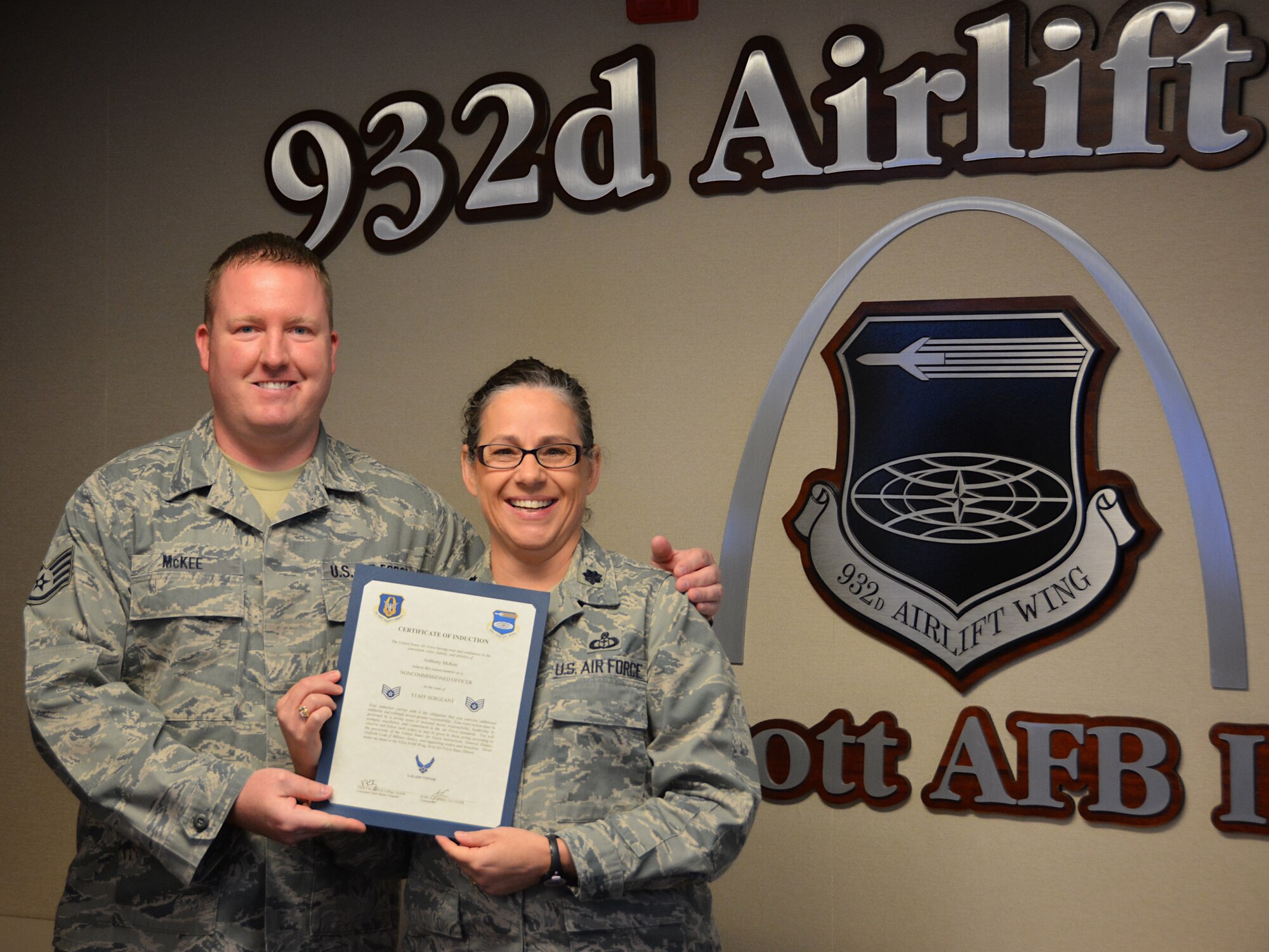 Lt. Col. Julie Novy, 932nd Airlift Wing director of staff, presented Staff Sgt. Anthony McKee with the noncommissioned officer certificate of induction during the July UTA. Staff Sgt. McKee is a safety representative at the 932nd Airlift Wing at Scott Air Force Base, Ill. (U.S. Air Force photo by Tech. Sgt. Jodi Ames)