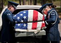 Members of the Eglin Air Force Base Honor Guard remove a casket from a hearse during the unit’s recent graduation ceremony. Approximately 12 new Airmen graduated from the 80-plus-hour course. The graduation performance includes flag detail, rifle volley, pall bearers and bugler for friends, family and unit commanders.  The Eglin Honor Guard provides their services to the base, Duke Field and more than 20 area counties making up approximately 20,000 square miles in the Florida and Alabama region.  (U.S. Air Force photo/Tech. Sgt. Sam King)