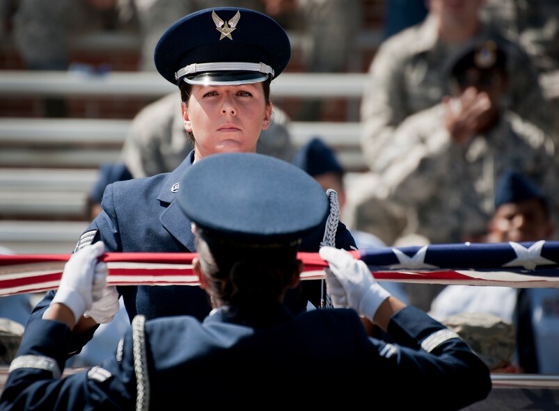 Senior Airman Christen Neel holds the flag during an Honor Guard graduation ceremony at Eglin Air Force Base, Fla. Approximately 12 new Airmen graduated from the 80-plus-hour course. The graduation performance includes flag detail, rifle volley, pall bearers and bugler for friends, family and unit commanders.  The Eglin Honor Guard provides their services to the base, Duke Field and more than 20 area counties making up approximately 20,000 square miles in the Florida and Alabama region.  (U.S. Air Force photo/Tech. Sgt. Sam King)
