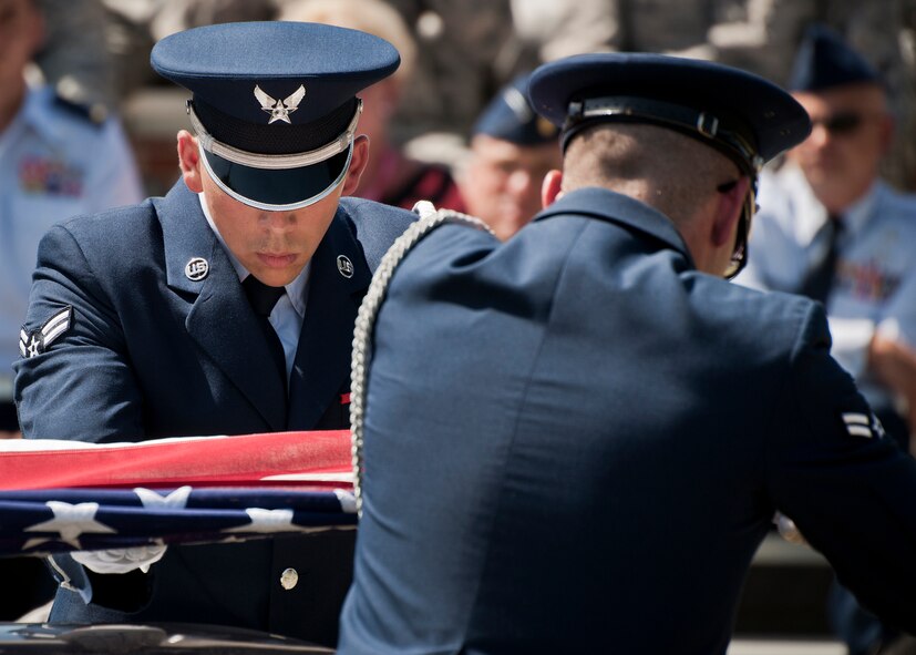 Airman 1st Class Logan Hall flattens out the flag during an Honor Guard graduation ceremony at Eglin Air Force Base, Fla. Approximately 12 new Airmen graduated from the 80-plus-hour course. The graduation performance includes flag detail, rifle volley, pall bearers and bugler for friends, family and unit commanders.  The Eglin Honor Guard provides their services to the base, Duke Field and more than 20 area counties making up approximately 20,000 square miles in the Florida and Alabama region.  (U.S. Air Force photo/Tech. Sgt. Sam King)