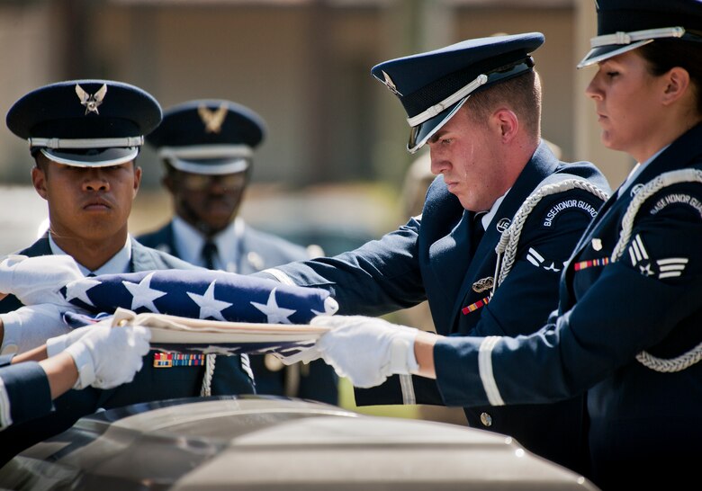 Airman 1st Class Brandon Pesci folds the flag during an Honor Guard graduation ceremony at Eglin Air Force Base, Fla. Approximately 12 new Airmen graduated from the 80-plus-hour course. The graduation performance includes flag detail, rifle volley, pall bearers and bugler for friends, family and unit commanders. The Eglin Honor Guard provides their services to the base, Duke Field and more than 20 area counties making up approximately 20,000 square miles in the Florida and Alabama region.  (U.S. Air Force photo/Tech. Sgt. Sam King)
