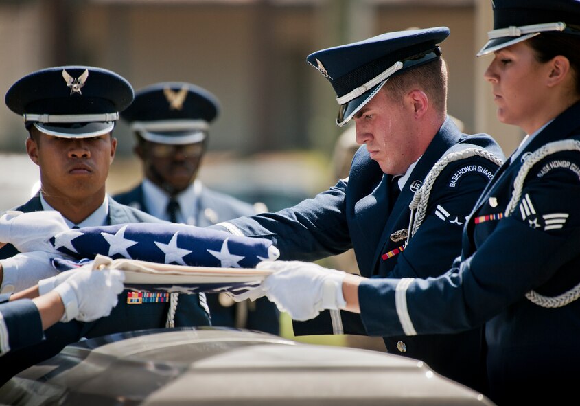 Airman 1st Class Brandon Pesci folds the flag during an Honor Guard graduation ceremony at Eglin Air Force Base, Fla. Approximately 12 new Airmen graduated from the 80-plus-hour course. The graduation performance includes flag detail, rifle volley, pall bearers and bugler for friends, family and unit commanders. The Eglin Honor Guard provides their services to the base, Duke Field and more than 20 area counties making up approximately 20,000 square miles in the Florida and Alabama region.  (U.S. Air Force photo/Tech. Sgt. Sam King)