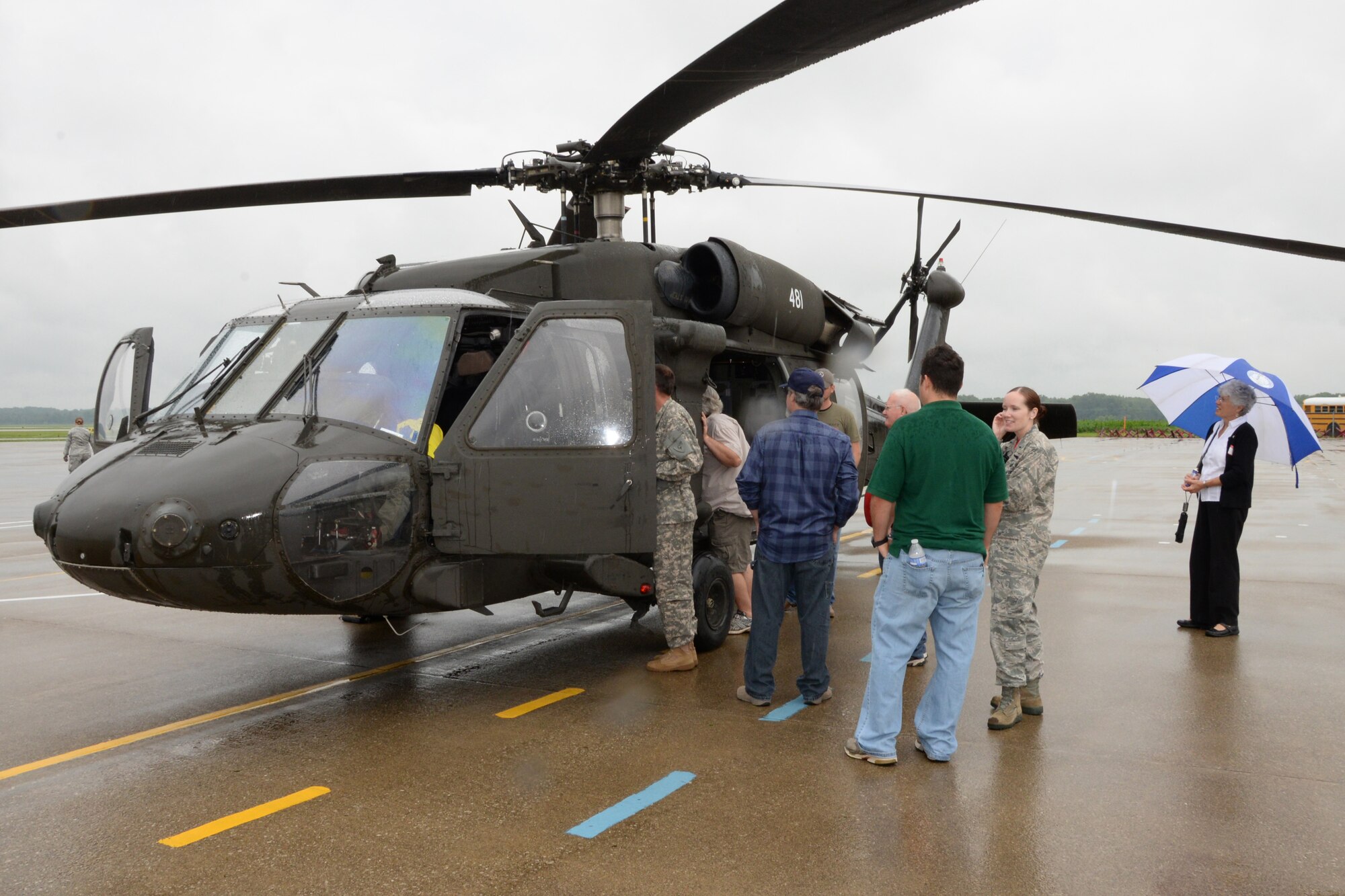 Distinguished guests receive a tour of a U.S. Army UH-60 Blackhawk during the Domestic Operations Expo at the 181st Intelligence Wing, Terre Haute, IN., July 10, 2015.  The expo highlighted the capabilities of the 181st IW and local organizations during a domestic event, such as a natural disaster. The 181st IW is ready, reliable, and relevant. (U.S. Air National Guard photo by Airman 1st Class Lonnie Wiram/Released)