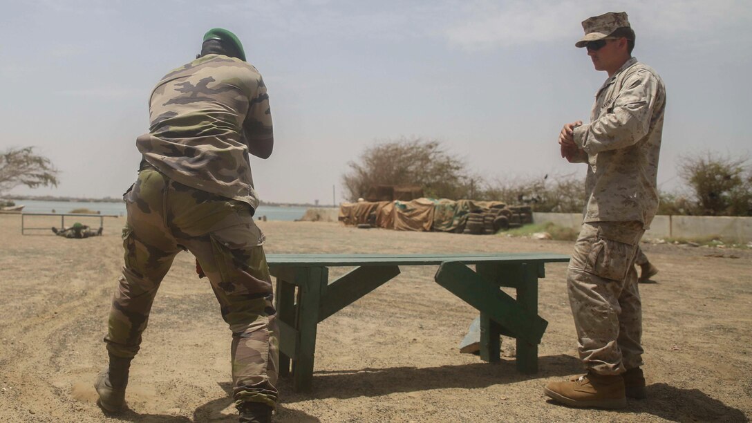Marine Cpl. Trevor Thompson, right, an infantryman with Special-Purpose Marine Air-Ground Task Force Crisis Response-Africa, observes as a member of the Seneglaese Compagnie Fusilier de Marin Commandos moves towards a simulated casualty during a basic skills competition in St. Louis, Senegal, July 2, 2015. More than 15 U.S. Marines and Sailors with the unit held a weapons and combat medical skills competition for more than 30 members of the Fusilier Marins in an effort to build and sustain infantry fundamentals.