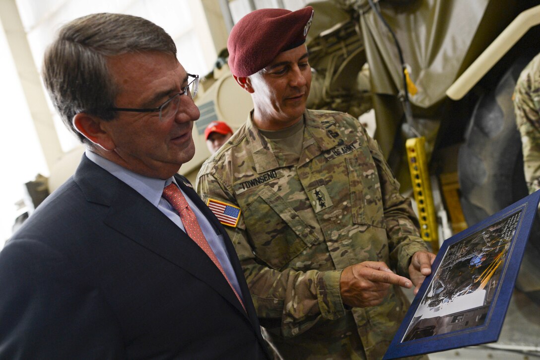 Army Lt. Gen. Stephen Townsend, commanding general of the XVIII Airborne Corps, presents Defense Secretary Ash Carter with a photo at Fort Bragg, N.C., July 11, 2015. Carter flew with soldiers are assigned to the 82nd Airborne Division's 2nd Brigade Combat Team and hosted a troop event during his visit to Fort Bragg.
