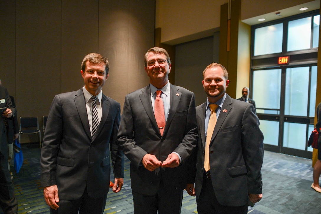 Defense Secretary Ash Carter poses with Peter Buttigieg, left, mayor of South Bend, Ind., and his chief of staff, Brian Pawlowski, right, at the 80th Annual Conference of the National Association of Counties in Charlotte, N.C., July 11, 2015. 