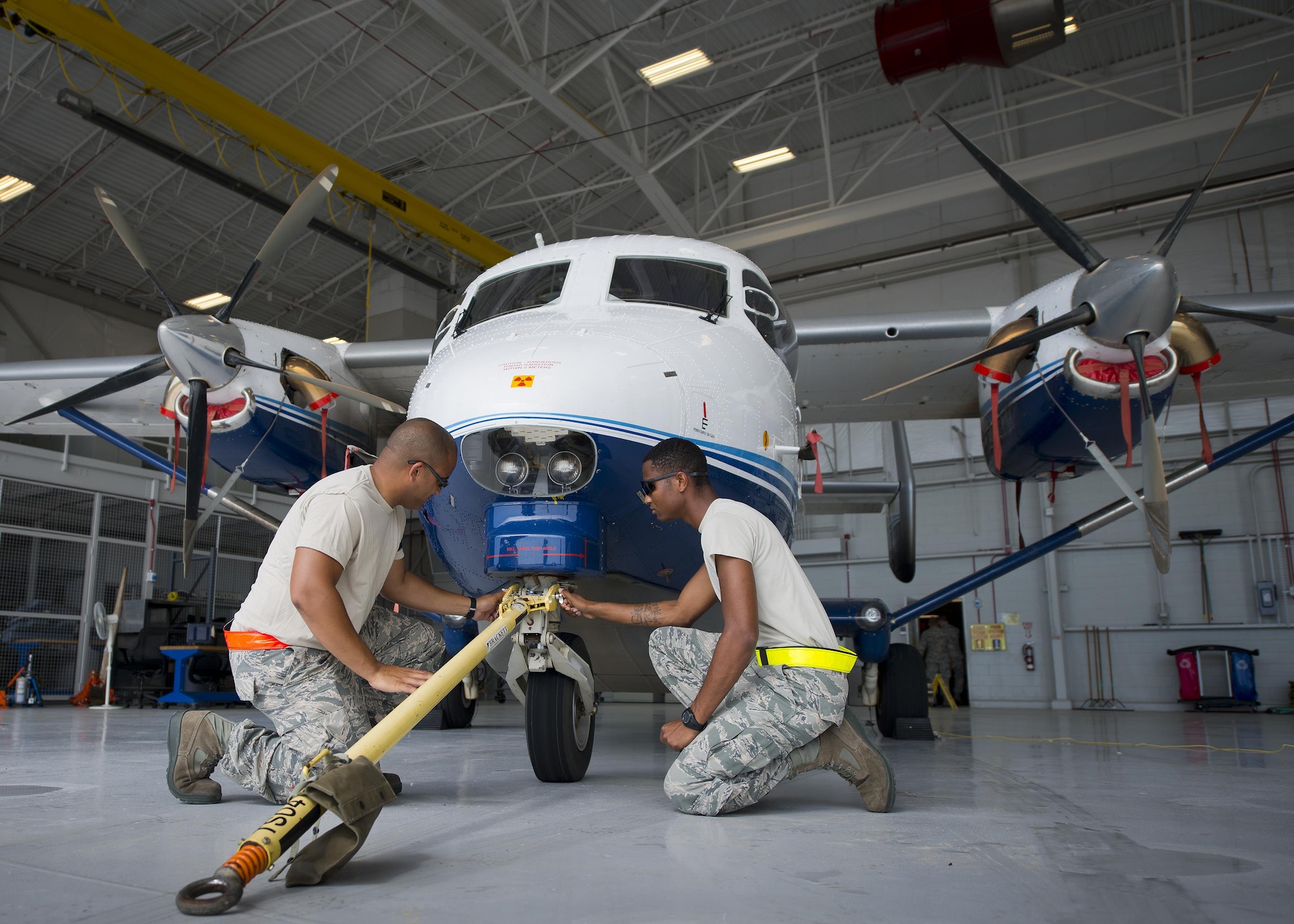 Senior Airman Kevin Kahn, and Airman Mario Hill, 919th Special Operations Maintenance Group, connect a tow bar onto a C-145 June 6 at Duke Field, Fla. The 919th SOMXG is comprised of 919th SOMXS, 919th SOAMXS, 919th SOMOF, and the 592nd SOAMXS. Their primary mission is the maintenance of the C-145 aircraft. (U.S. Air Force photo/Tech. Sgt. Sam King)
