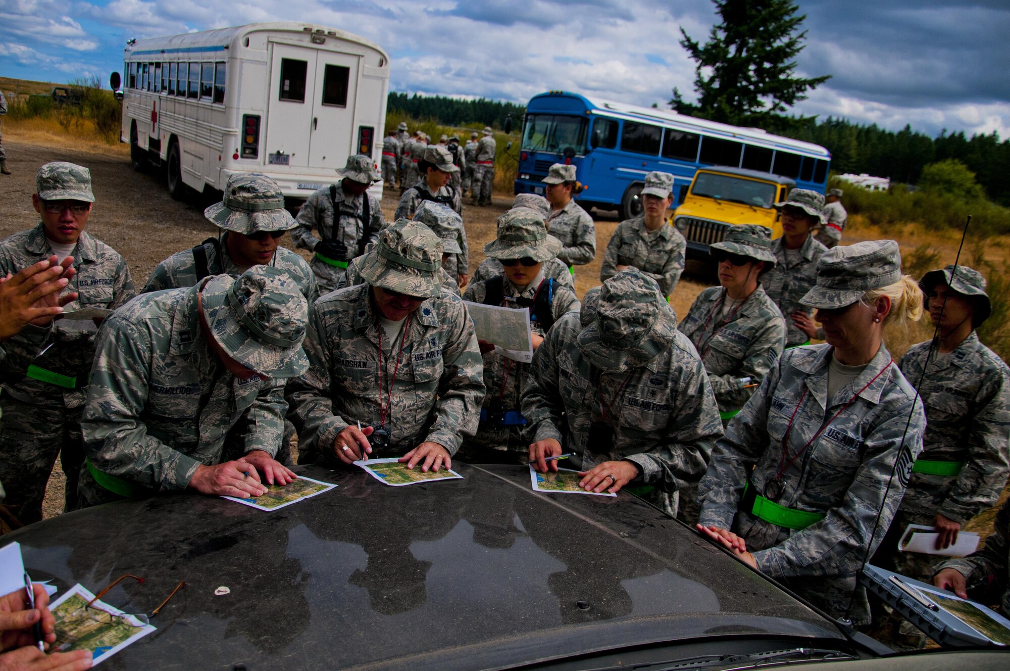 Medics from the 446th Aeromedical Staging Squadron map out their routes during land navigation training for the Care Under Fire exercise at Joint Base Lewis-McChord, July 12, 2015. The Care under Fire exercise was designed locally by the 446th ASTS in order to simulate combat conditions and establish team oriented training scenarios. Medics were offered land navigation training in order to enhance their combat readiness in austere locations. (U.S. Air Force photo by Senior Airman Daniel Liddicoet)