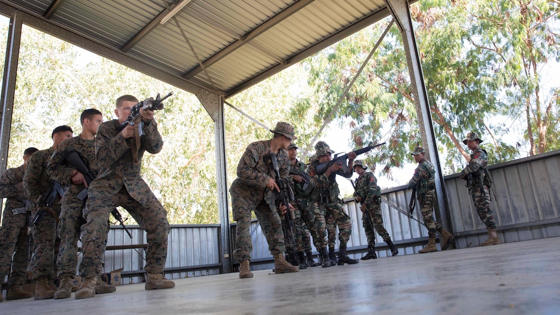 A platoon of U.S. Marines with Company A, 1st Battalion, 4th Marine Regiment, Marine Rotational Force – Darwin, demonstrate weapons presentation during Exercise Koa Moana 15.2 in Dili, Timor-Leste, June 24. The platoon of Marines conducted a bilateral exercise with one platoon of the Timor-Leste Defence Force’s land component of the naval force and one platoon of their Marines, focusing on the fundamentals of squad and platoon-level tasks. The bilateral training included building room clearing, urban movement and patrolling. The MRF-D six-month deployment demonstrates how the Marine Air Ground Task Force is equipped and organized to carry out national objectives in cooperation with our national and international partners.