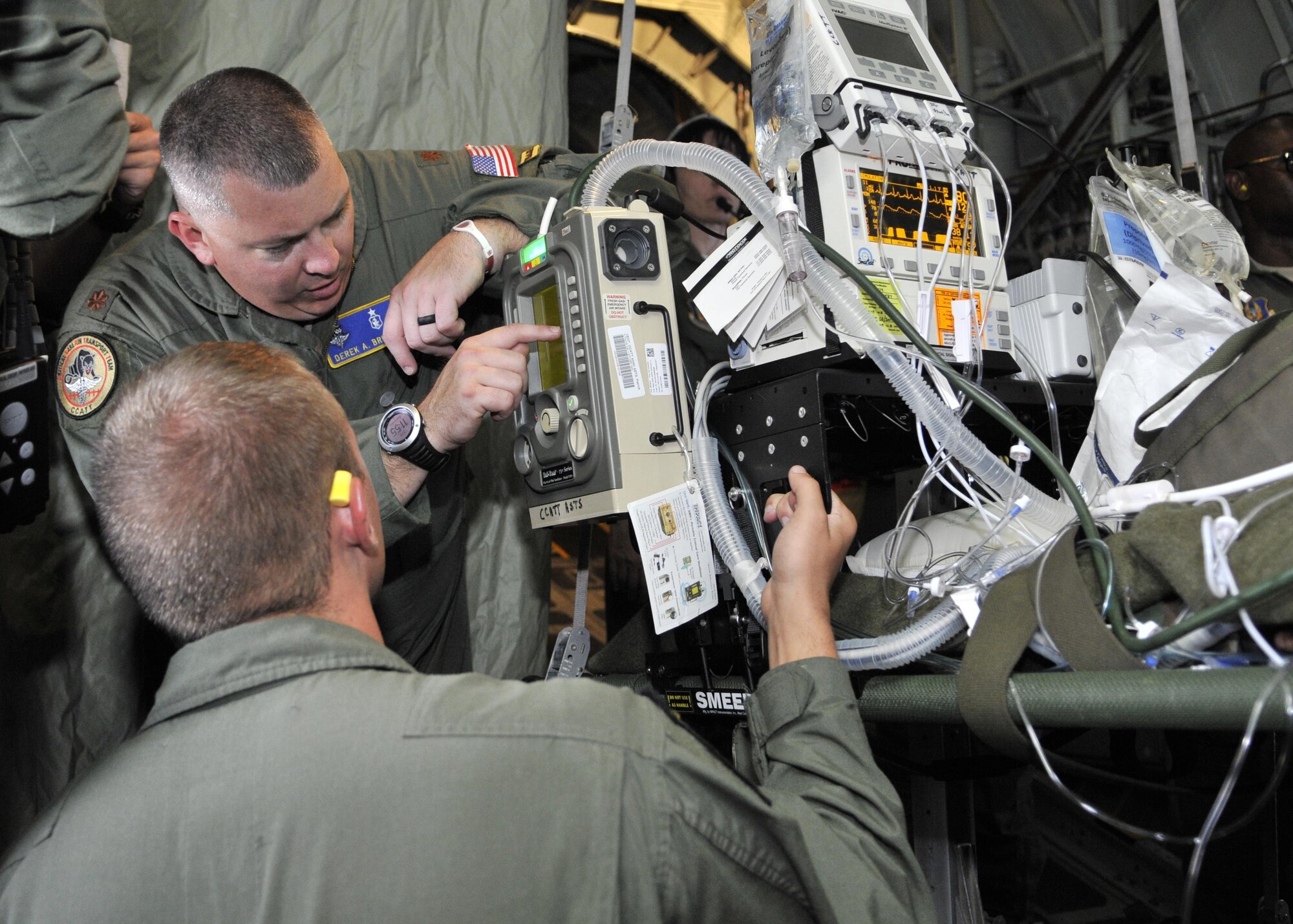 Maj. Derek Brumley, Kentucky Air National Guardsman assigned to the 123rd Medical Group and Staff Sgt. David Rudd, 920th Rescue Wing aeromedical staging squadron, check life support equipment on a C-130/H rescue aircraft during MEDBEACH 2015 joint service exercise at Patrick Air Force Base, Fla., July 11, 2015. This exercise prepares military medical personnel for deployments by providing realistic scenarios that they may see during a wartime situation. (U.S. Air Force photo by Tech. Sgt. Michael Means)
