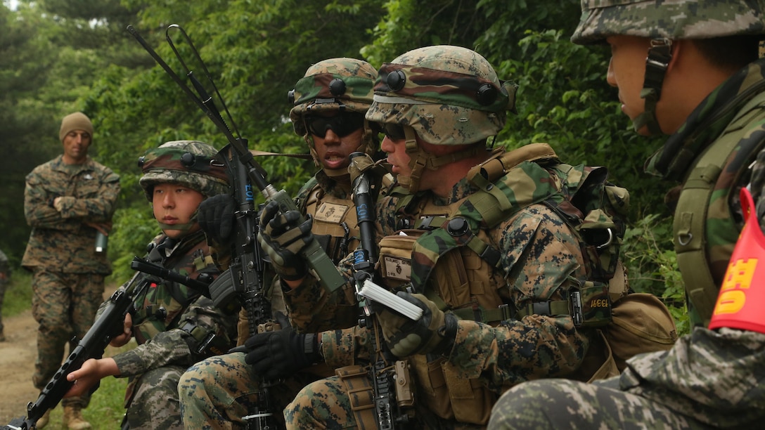 U.S. Marine Corps Cpl. Jared Allen, second from the right, calls in a simulated roadside bomb as part of the culminating event of Korean Marine Exchange Program 15-11 in Pohang, Republic of Korea, May 16, 2015. KMEP 15-11 is focused on exchanging law enforcement techniques, tactics and procedures while enhancing relations across the Korean Peninsula. Allen is a military policeman with 3rd Law Enforcement Battalion, III Marine Expeditionary Force Headquarters Group, III MEF. 