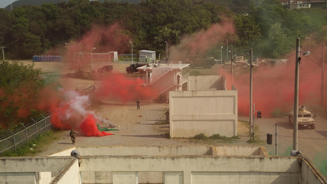 Republic of Korea and U.S. Marines use smoke screens to enter MOUT town during the culminating event of Korean Marine Exchange Program 15-11 in Pohang, Republic of Korea, May 16, 2015. Using the smoke screen provides cover for the Marines to execute urban operations under visual concealment. KMEP 15-11 is focused on exchanging law enforcement techniques, tactics and procedures while enhancing relations across the Korean Peninsula. 