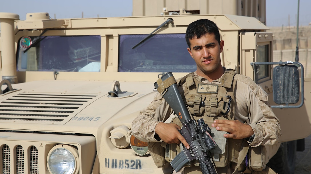 Lance Cpl. Ali J. Mohammed poses for a photo with a Humvee aboard Al Taqaddum Air Base, Iraq, July 4, 2015. Mohammed is originally from Baghdad and is now serving in the U.S. Marine Corps as a supply Marine. He is currently deployed as an Arabic interpreter for Task Force Al Taqaddum.