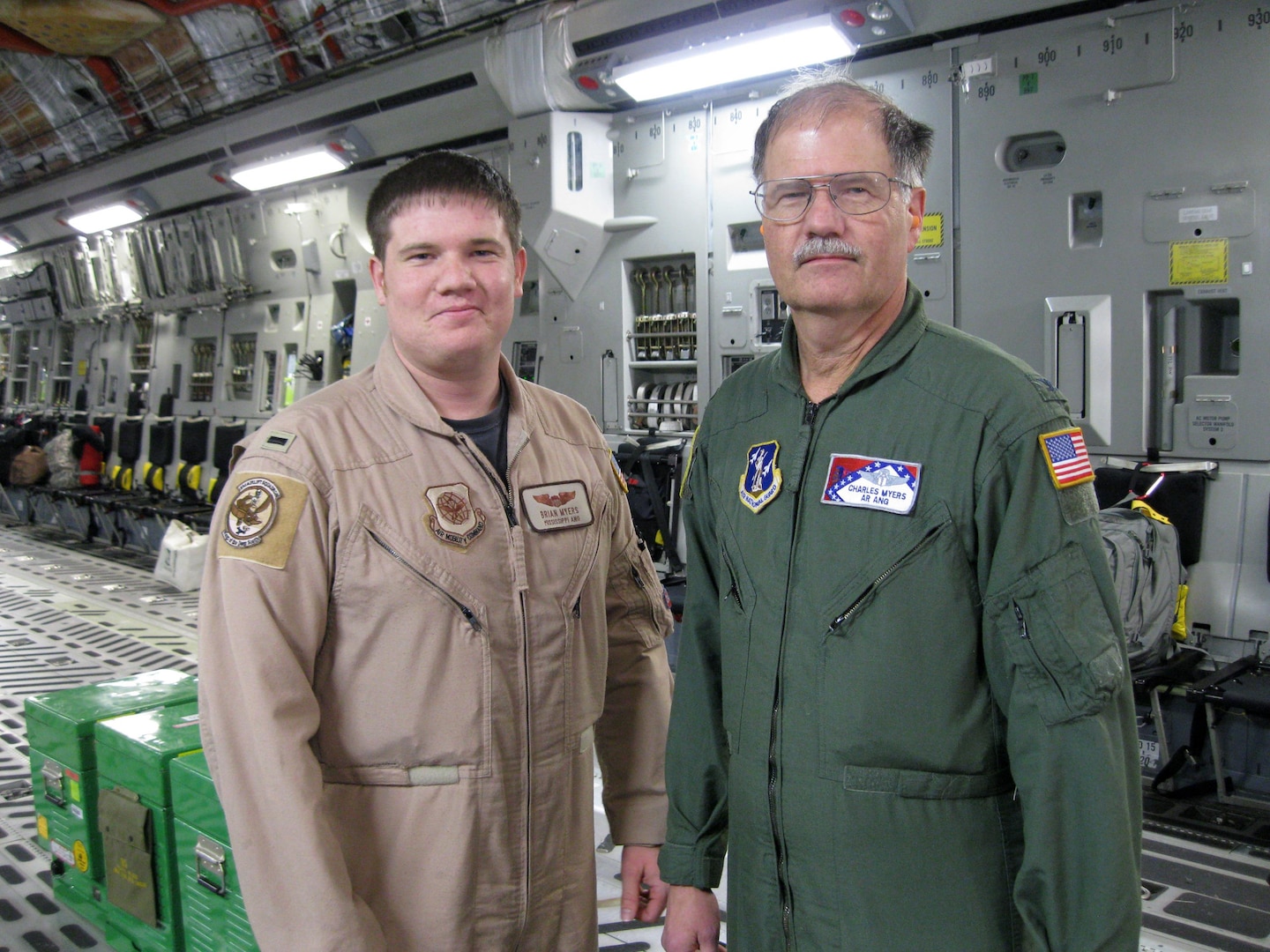 Air Force 1st Lt. Brian Myers, a C-17 Globemaster III pilot, 183rd Airlift Squadron, Mississippi National Guard, and his father, Air Force Col. Charles Myers, state air surgeon for the Arkansas National Guard, pose for a photo after landing at Joint Base Andrews Naval Air Facility in Camp Springs, Md., March 15, 2011. The father-and-son duo had the opportunity to work alongside one another as part of the Air Guard CCATT mission.