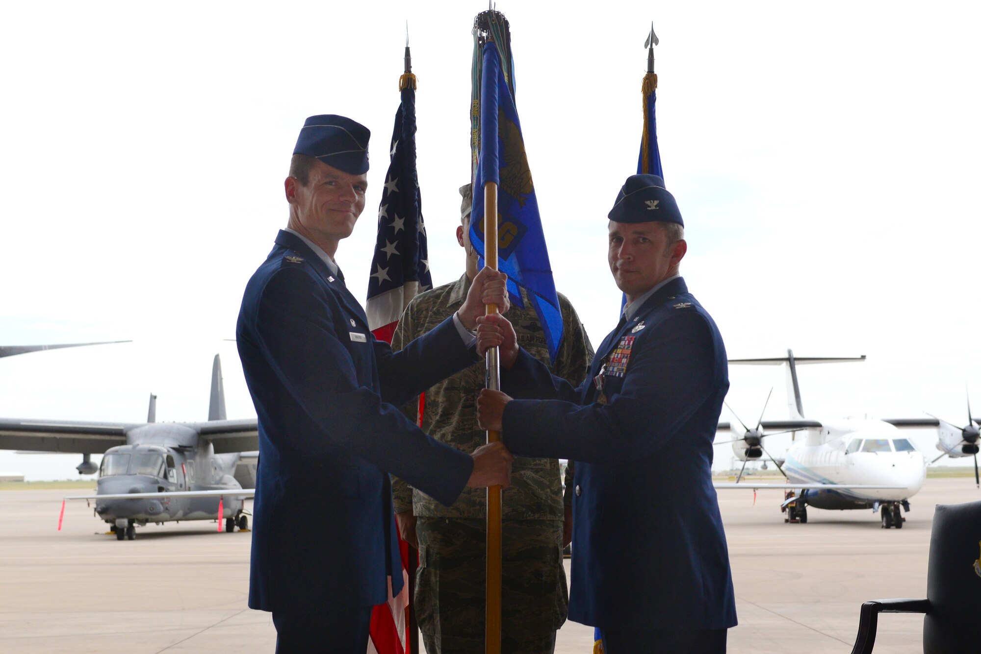 U.S. Air Force Col. Ben Maitre, 27th Special Operations Wing commander, presents the guideon to Col. Justin Hoffman, 27th Special Operations Group commander, during the 27th SOG assumption of command ceremony July 2, 2015 at Cannon Air Force Base, N.M. Hoffman will oversee 10 squadrons with the mission of accomplishing global special operations taskings as an Air Force component member of the United States Special Operations Command. (U.S. Air Force photo/Senior Airman Eboni Reece)  