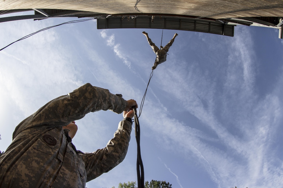 Army Reserve drill sgt., Staff Sgt. William Atsitte, B Company, 3-321st Inf. Regt., 104th Training Division (LT), runs belay as Staff Sgt. Chris Walker, B Company, 3-321st Inf. Regt., 104th Training Division (LT), rappels during the certification on Victory Tower at Fort Jackson, S.C. at their two-week annual training. (U.S. Army photo by Sgt. 1st Class Brian Hamilton)