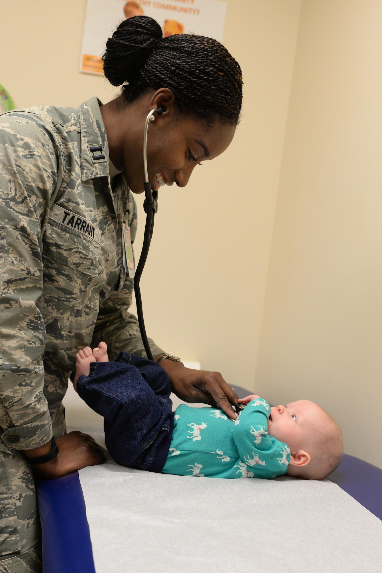 Capt. Chauncey Tarrant, 375th Medical Operations Squadron general pediatrician, examines a patient at the 375th Medical Group at Scott Air Force Base, Illinois on April 1, 2015. Tarrant, along with four other pediatricians, takes care of the health needs of military children at Scott. (U.S. Air Force photo by Senior Airman Sarah Hall-Kirchner/Released)