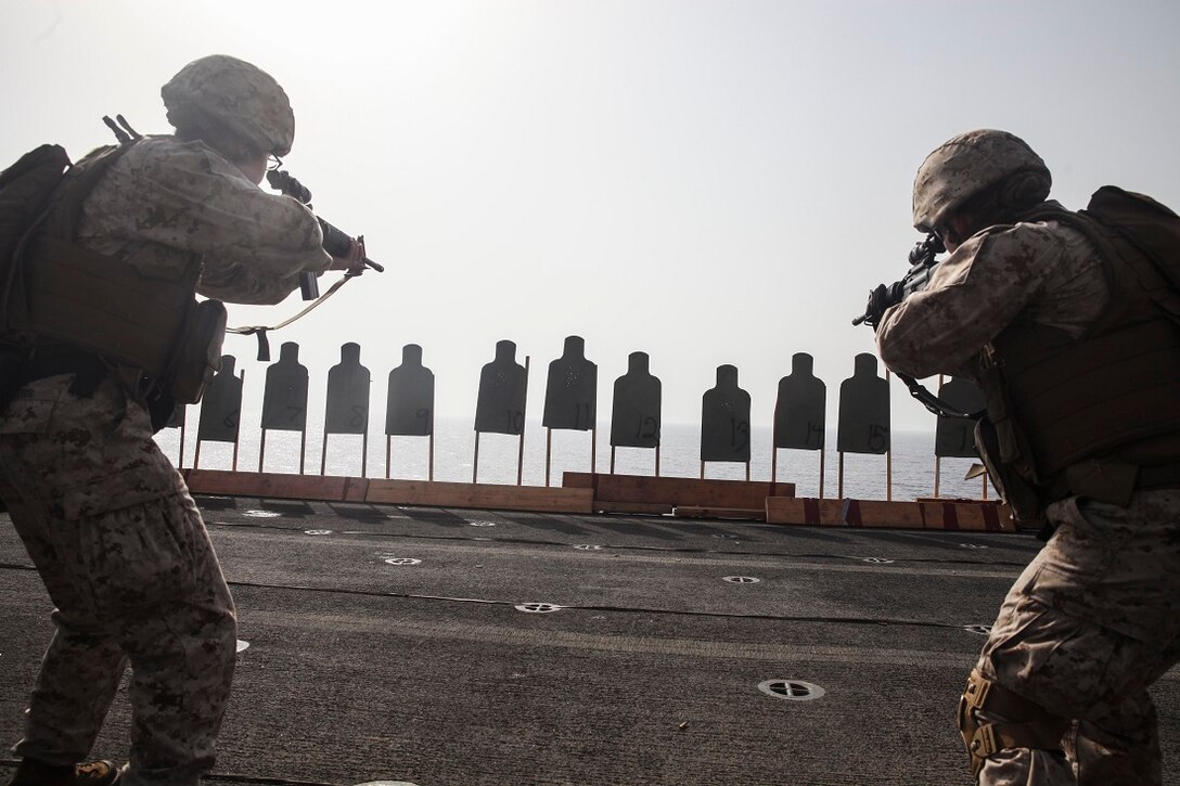 GULF OF ADEN (July 7, 2015) U.S. Marines with the 15th Marine Expeditionary Unit aim at their targets during a deck shoot aboard the amphibious assault ship USS Essex (LHD 2). These Marines are participating in a week-long screening program to become a member of a Female Engagement Team. The 15th MEU is embarked on the Essex ARG and deployed to maintain regional security in the U.S. 5th Fleet area of operations. (U.S. Marine Corps photo by Cpl. Elize McKelvey/Released)