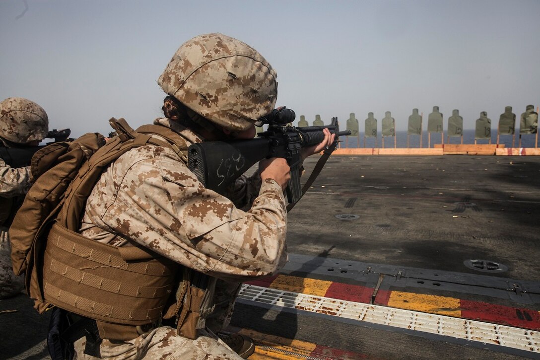 GULF OF ADEN (July 7, 2015) A U.S. Marine with the 15th Marine Expeditionary Unit aims at her target during a deck shoot aboard the amphibious assault ship USS Essex (LHD 2). This was part of a week-long screening program to become a member of a Female Engagement Team. The 15th MEU is embarked on the Essex ARG and deployed to maintain regional security in the U.S. 5th Fleet area of operations. (U.S. Marine Corps photo by Cpl. Elize McKelvey/Released)