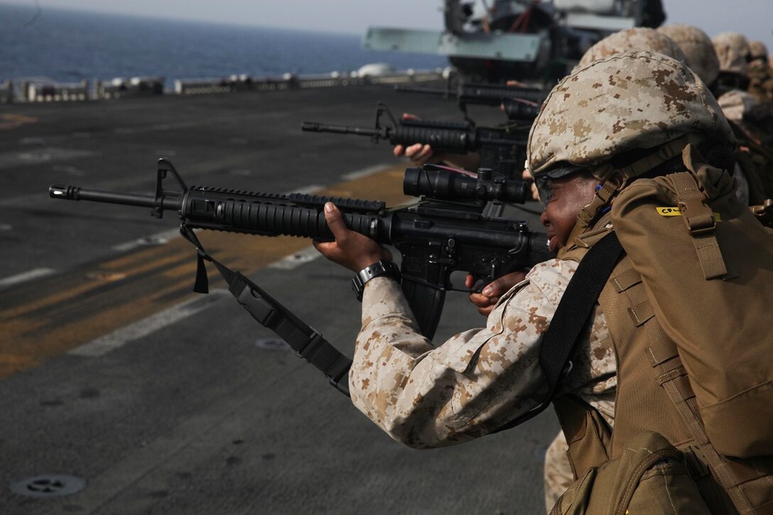 GULF OF ADEN (July 7, 2015) U.S. Marine Cpl. Tiffany Kingsley aims at her target during a deck shoot aboard the amphibious assault ship USS Essex (LHD 2). Kingsley is a food service specialist with the 15th Marine Expeditionary Unit, and was participating in a week-long screening program to become a member a Female Engagement Team. The 15th MEU is embarked on the Essex ARG and deployed to maintain regional security in the U.S. 5th Fleet area of operations. (U.S. Marine Corps photo by Cpl. Anna Albrecht/Released)
