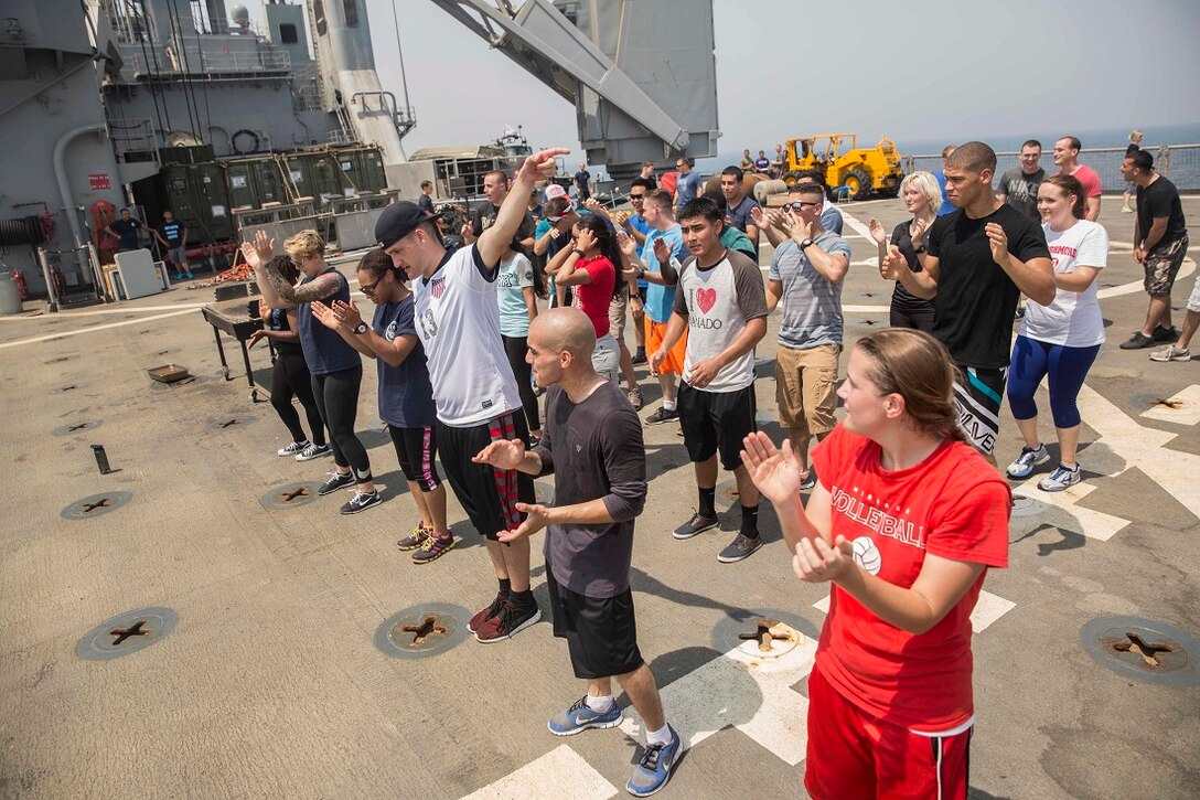 ARABIAN GULF (July 4, 2015) U.S. Marines and Sailors with the 15th Marine Expeditionary Unit and Essex Amphibious Group blow off some steam by dancing during a steel beach in observance of Independence Day aboard the dock landing ship Rushmore (LSD 47). Marines with Combat Logistics Battalion 15, 15th MEU, celebrated with the reading of the Declaration of Independence and with an American style barbeque on the flight deck. The 15th MEU is embarked on the Essex ARG and deployed to maintain regional security in the U.S. 5th Fleet area of operations. (U.S. Marine Corps photo by Sgt. Emmanuel Ramos/Released)