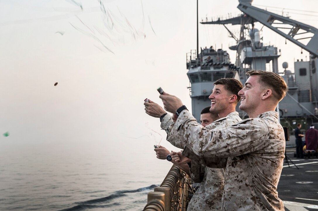 ARABIAN GULF (July 4, 2015) U.S. Marines with the 15th Marine Expeditionary Unit pop party poppers in celebration during a steel beach in observance of Independence Day aboard the dock landing ship USS Rushmore (LSD 47). Marines with Combat Logistics Battalion 15, 15th MEU, celebrated with the reading of the Declaration of Independence and with an American style barbeque on the flight deck. The 15th MEU is embarked on the Essex Amphibious Ready Group and deployed to maintain regional security in the U.S. 5th Fleet area of operations. (U.S. Marine Corps photo by Sgt. Emmanuel Ramos/Released)