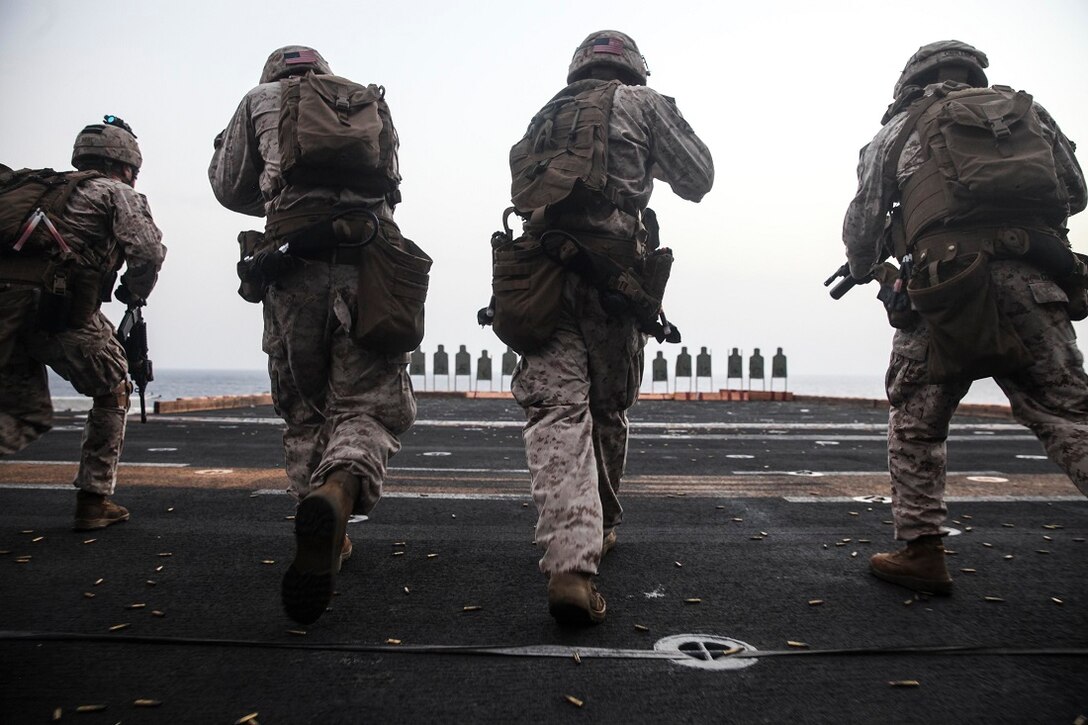 GULF OF ADEN (July 7, 2015) U.S. Marines with the 15th Marine Expeditionary Unit’s Maritime Raid Force move toward their targets during a deck shoot aboard amphibious assault ship USS Essex (LHD 2). The MRF practiced different types of drills including shooting on the move and multiple target engagements. The 15th MEU is embarked on the Essex ARG and deployed to maintain regional security in the U.S. 5th Fleet area of operations. (U.S. Marine Corps Photo by Cpl. Elize McKelvey/Released)