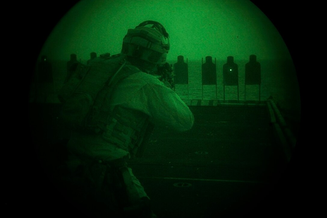 GULF OF ADEN (July 7, 2015) A U.S. Marine with the 15th Marine Expeditionary Unit’s Maritime Raid Force aims at his target during a low-light deck shoot aboard the amphibious assault ship USS Essex (LHD 2). The MRF practiced shooting in low-light conditions to familiarize themselves with their equipment and ensure they can shoot accurately. The 15th MEU is embarked on the Essex ARG and deployed to maintain regional security in the U.S. 5th Fleet area of operations. (U.S. Marine Corps photo by Cpl. Anna Albrecht/Released)