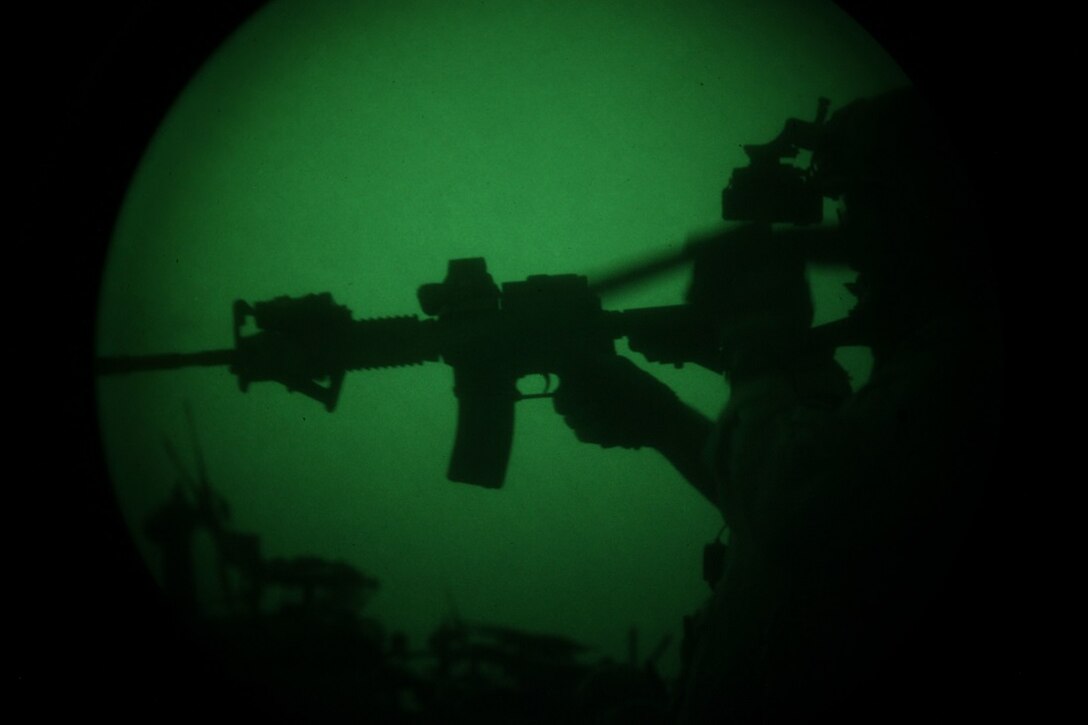 GULF OF ADEN (July 7, 2015) A U.S. Marine with the 15th Marine Expeditionary Unit’s Maritime Raid Force aims at his target during a low-light deck shoot aboard the amphibious assault ship USS Essex (LHD 2). The MRF practiced shooting in low-light conditions to familiarize themselves with their equipment and ensure they can shoot accurately. The 15th MEU is embarked on the Essex ARG and deployed to maintain regional security in the U.S. 5th Fleet area of operations. (U.S. Marine Corps photo by Cpl. Anna Albrecht/Released)