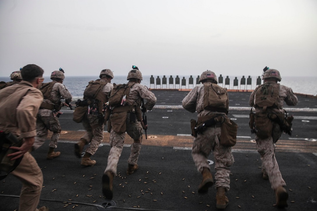 GULF OF ADEN (July 7, 2015) U.S. Marines with the 15th Marine Expeditionary Unit’s Maritime Raid Force run toward their targets during a deck shoot aboard amphibious assault ship USS Essex (LHD 2). The MRF practiced different types of drills including shooting on the move and multiple target engagements. The 15th MEU is embarked on the Essex ARG and deployed to maintain regional security in the U.S. 5th Fleet area of operations. (U.S. Marine Corps Photo by Cpl. Elize McKelvey/Released)