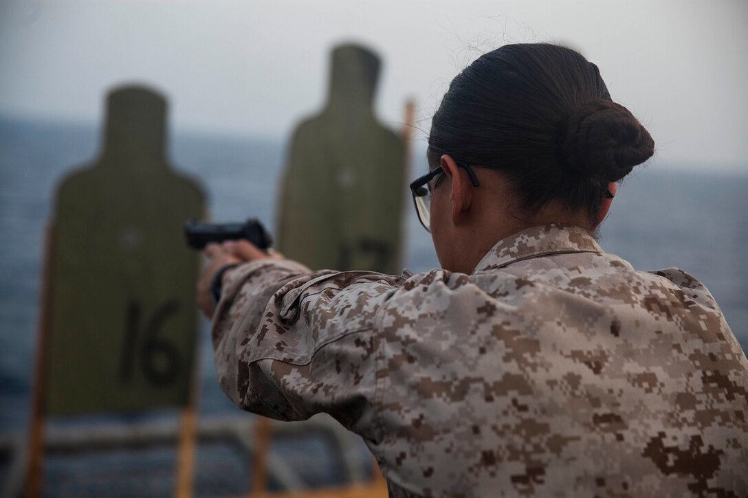 GULF OF ADEN (July 8, 2015) U.S. Marine Cpl. Justine Woodend aims at her target during a deck shoot aboard the amphibious assault ship USS Essex (LHD 2). Woodend is with Combat Logistics Battalion 15, 15th Marine Expeditionary Unit, and is participating in a week-long screener to become a member of a Female Engagement Team. The 15th MEU is embarked aboard the Essex Amphibious Ready Group and deployed to maintain regional security in the U.S. 5th Fleet area of operations. (U.S. Marine Corps photo by Cpl. Anna Albrecht/Released)