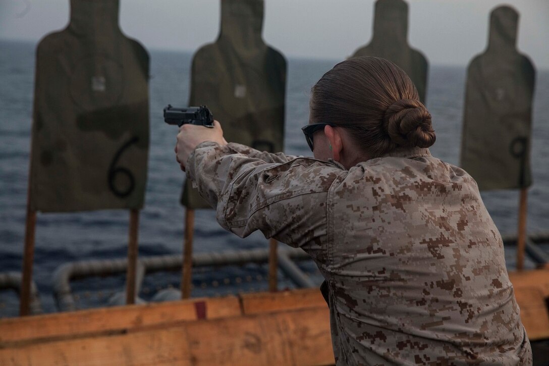 GULF OF ADEN (July 8, 2015) U.S. Marine Sgt. Taylor Harris aims at her target during a deck shoot aboard the amphibious assault ship USS Essex (LHD 2). Harris is a member of Medium Marine Tiltrotor Squadron 161 (Reinforced), 15th Marine Expeditionary Unit, and is participating in a week-long screener to become a member of a Female Engagement Team. The 15th MEU is embarked aboard the Essex Amphibious Ready Group and deployed to maintain regional security in the U.S. 5th Fleet area of operations. (U.S. Marine Corps photo by Cpl. Anna Albrecht/Released)
