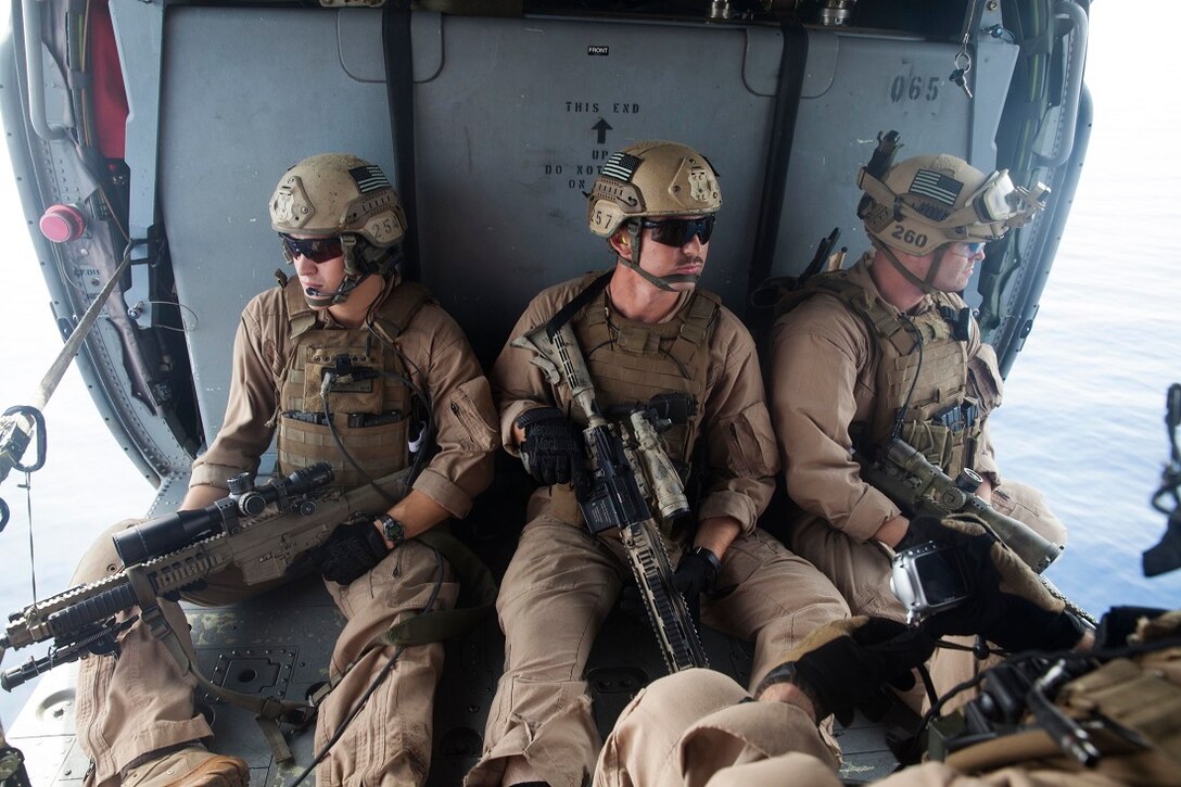 GULF OF ADEN (July 7, 2015) U.S. Marines with the 15th Marine Expeditionary Unit’s Maritime Raid Force depart the amphibious assault ship USS Essex (LHD 2) in an MH-60S Sea Hawk from the “Blackjacks” of Helicopter Sea Combat Squadron 21. Marines with the MRF practiced aerial sniping from a helicopter to improve their accuracy shooting from the air. The 15th MEU is embarked on the Essex Amphibious Ready Group and deployed to maintain regional security in the U.S. 5th Fleet area of operations. (U.S. Marine Corps photo by Cpl. Anna Albrecht/Released)